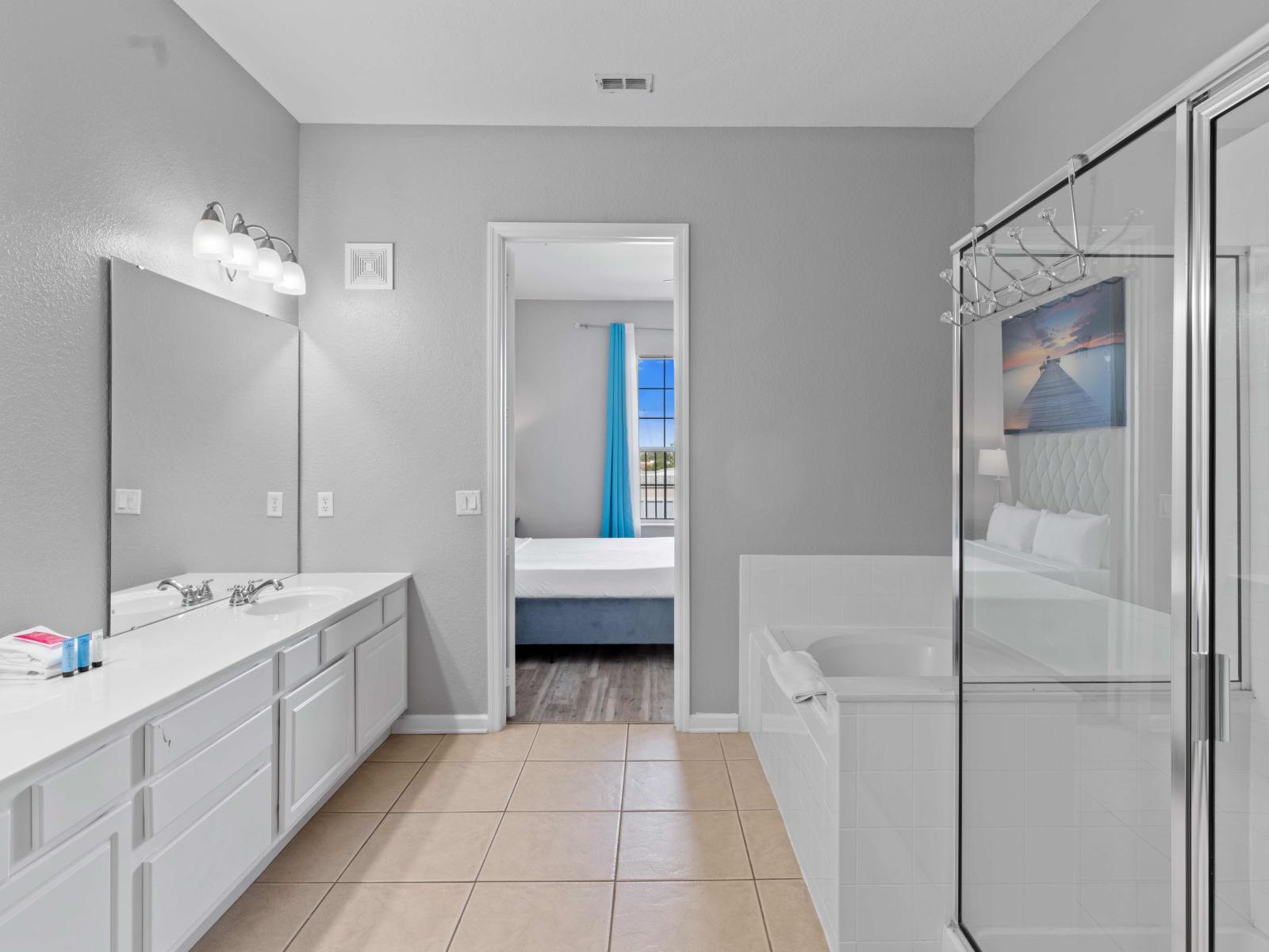 Enjoy a spa-like experience in the master bathroom, featuring a walk-in shower, bathtub, and double vanity mirrors for ultimate relaxation and convenience.