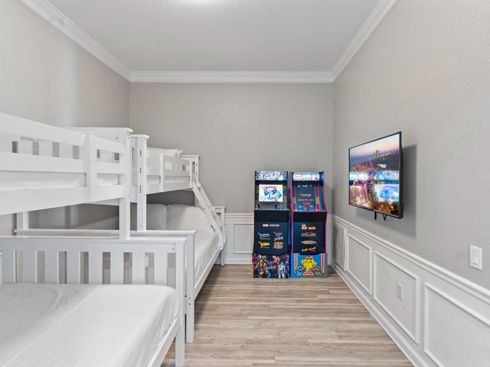 Explore our bonus room featuring two bunk beds (single over double) and arcade games, perfect for fun-filled nights and comfortable accommodations.