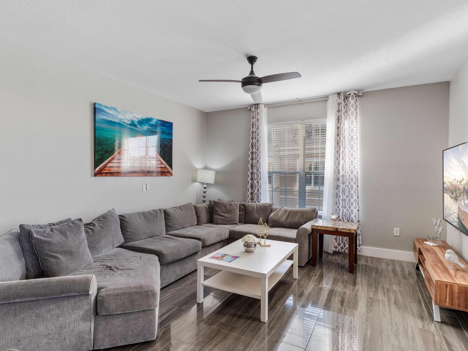 Unwind in comfort and style in this spacious living area of the condo in Orlando - A welcoming retreat with cozy sofas where relaxation meets elegance. - Availability of smart TV and Netflix - Thoughtfully designed bright and airy windows