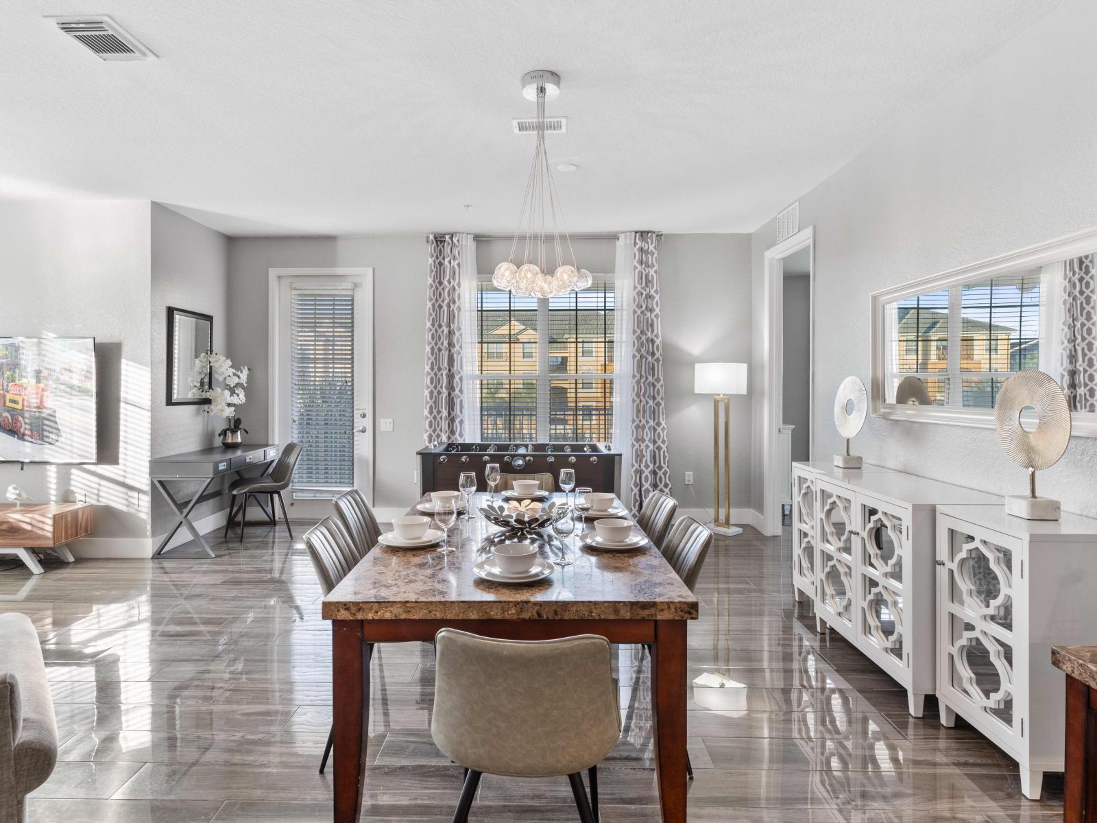 Welcoming Dining area of the condo in Orlando - A space where every meal becomes a cherished occasion. - Gather around and enjoy your meals with your loved ones - Gloriously organized 6 persons dinning table under a majestic chandelier