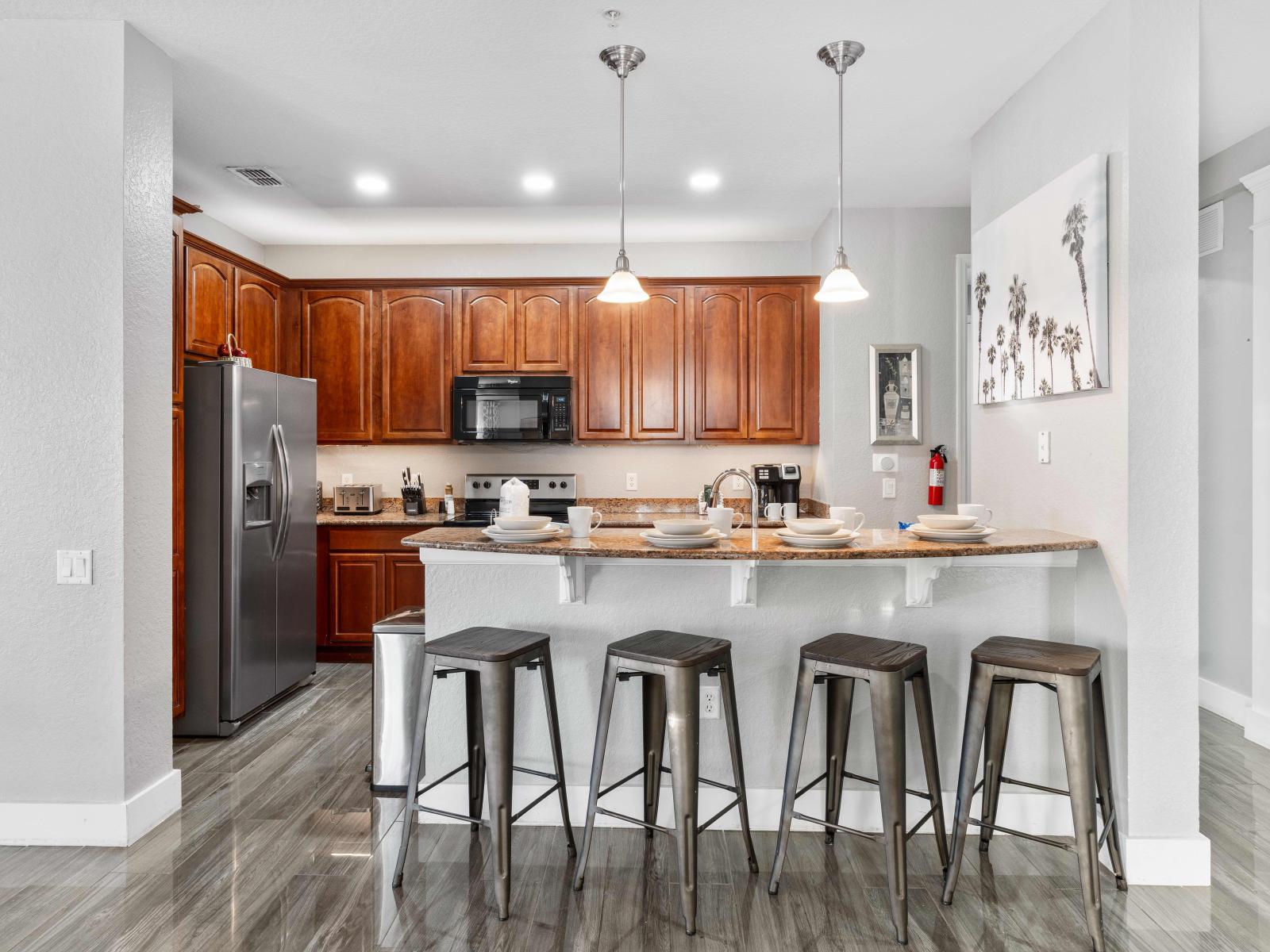 Indulge in culinary heaven of the condo in Orlando - Fully equipped kitchen with accessories and stainless steel appliances - Charming breakfast bar with high chairs available - Plenty of storage space - Stunning wooden furnished floor