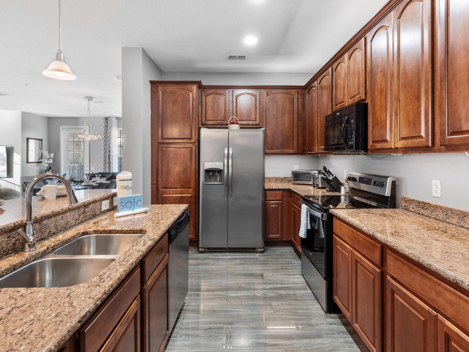 Sleek Kitchen of the condo in Orlando - Provides plenty of storage space - This culinary haven is perfect for preparing gourmet meals or enjoying casual breakfasts. - Soft lighting enlacing the beauty of kitchen - All kitchen accessories available