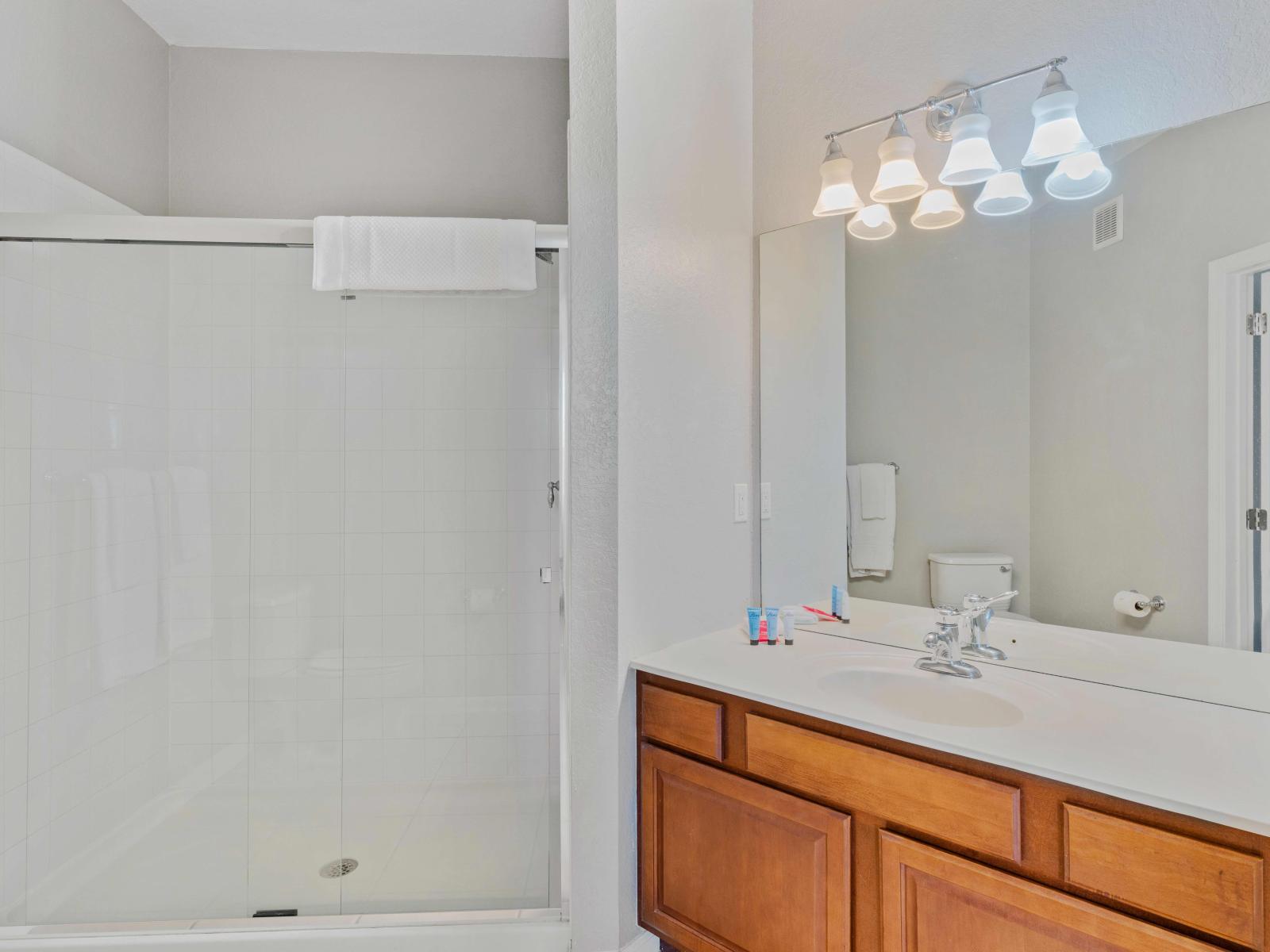 Embrace modern elegance in the en-suite bathroom with its spacious walk-in shower. A sleek retreat where luxury meets functionality, promising rejuvenation and style in every moment.