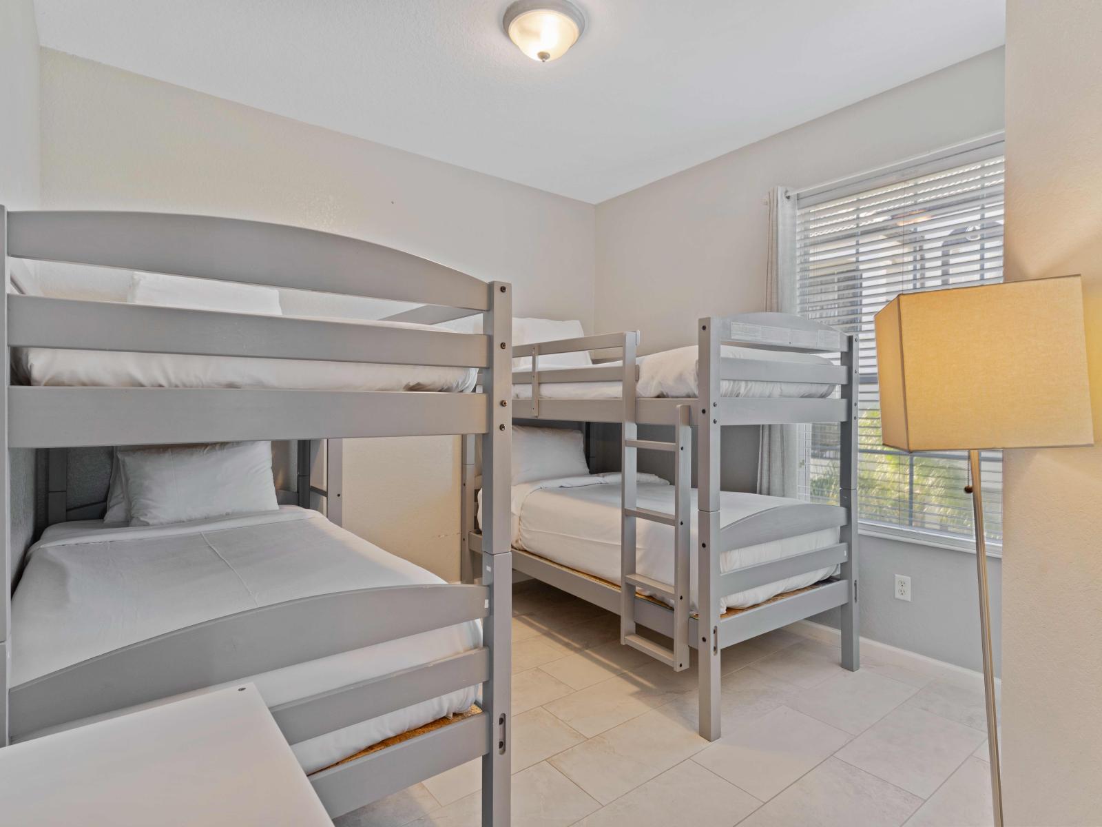 Bedroom 3 welcomes guests with two single-size bunk beds, creating a cozy retreat for rest and relaxation. A charming space promising fun-filled nights and cherished memories amidst its snug confines.