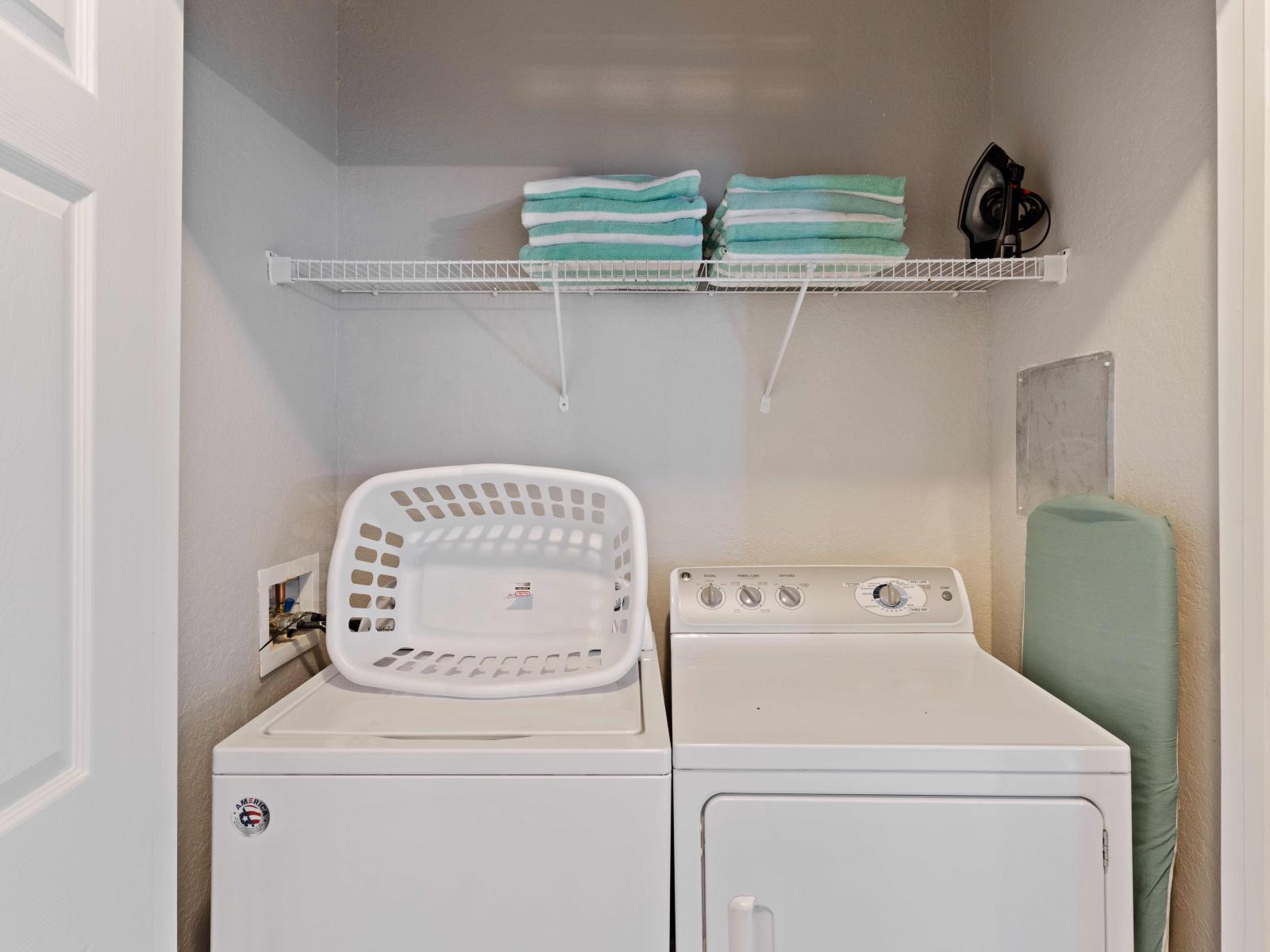 Behold the laundry room equipped with a full-size washer and dryer, offering convenience and efficiency for all your laundry needs.