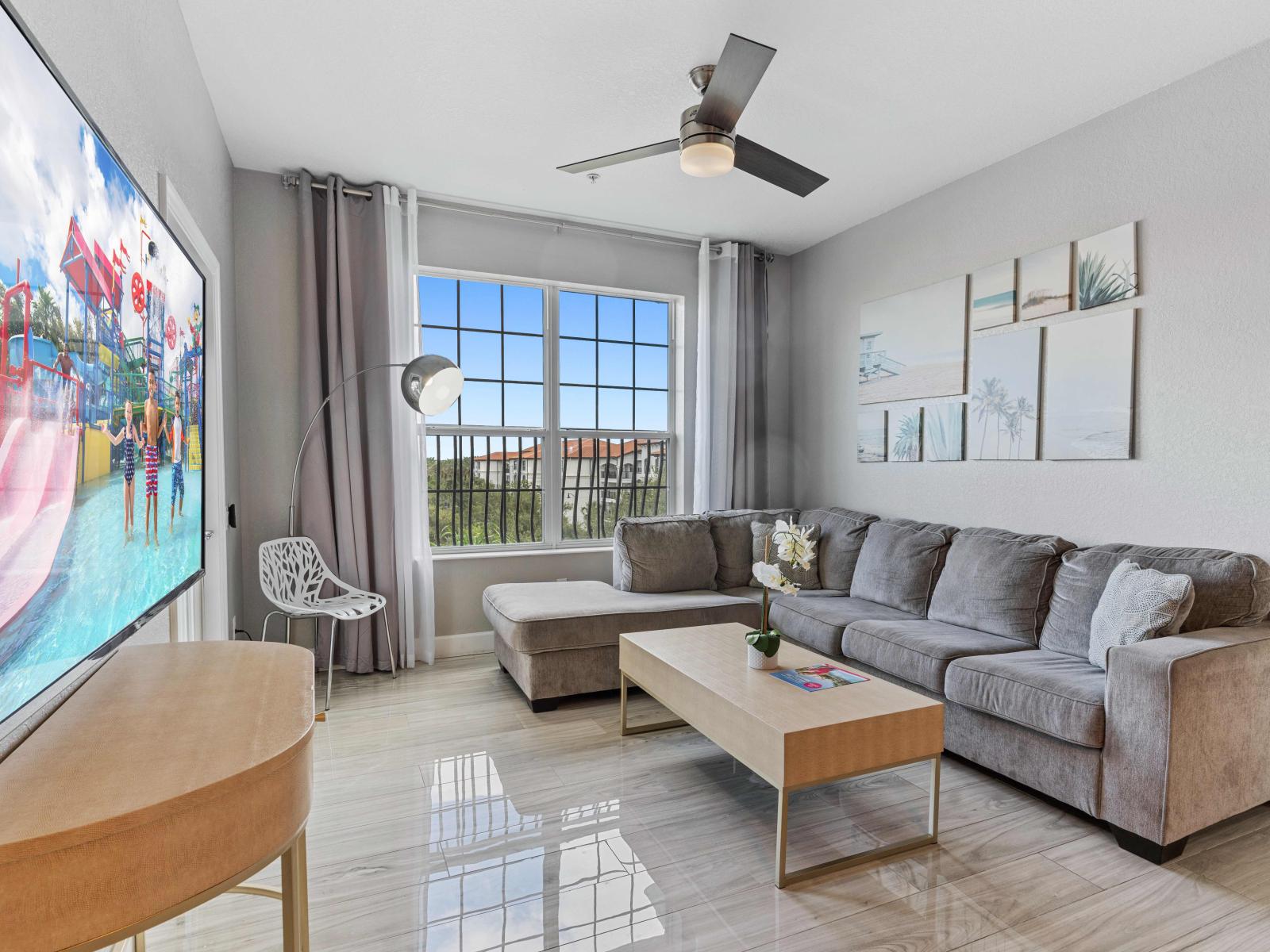 Exquisite living area of the condo in Orlando Florida - Sleek design, high-end finishes, and cozy accents create a perfect balance - Comfy sofas for relaxation - Smart TV for entertainment