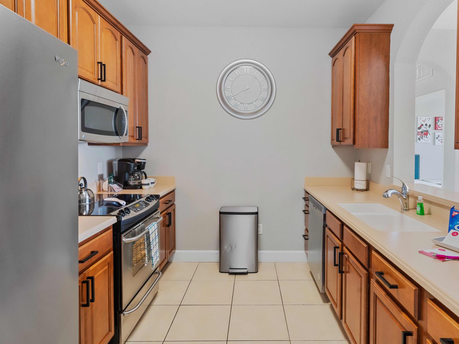 Polished kitchen of the condo in Orlando Florida - fully equipped kitchen with stainless steel appliances - Spacious countertop - Sufficient storage for ingredients and cookware