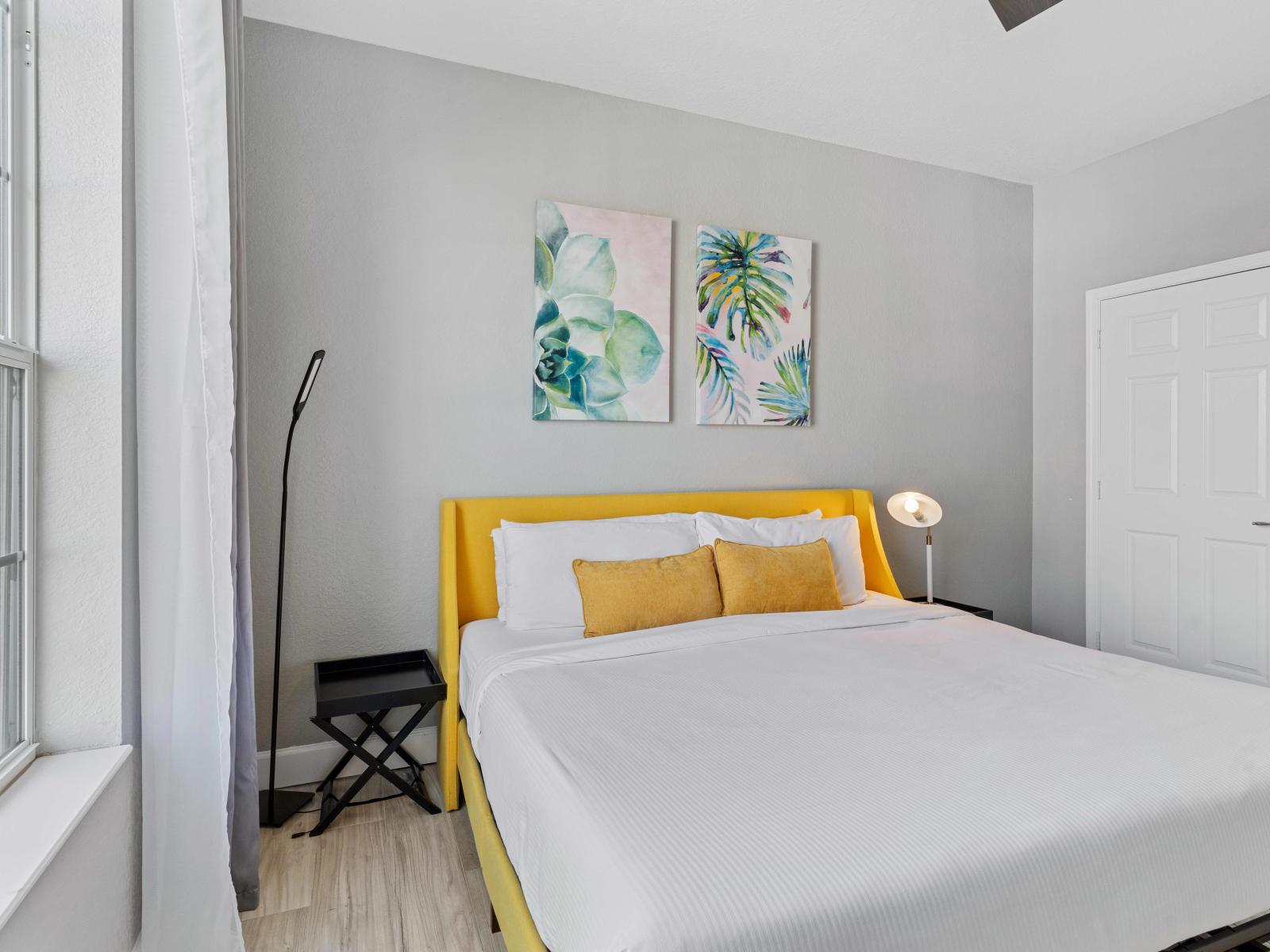 Elegant master bedroom with a perfect blend of design nestled in Orlando Florida - Indulge in breathtaking views through the bedroom window with natural light - High-quality mattress, soft pillows ensuring a restful night