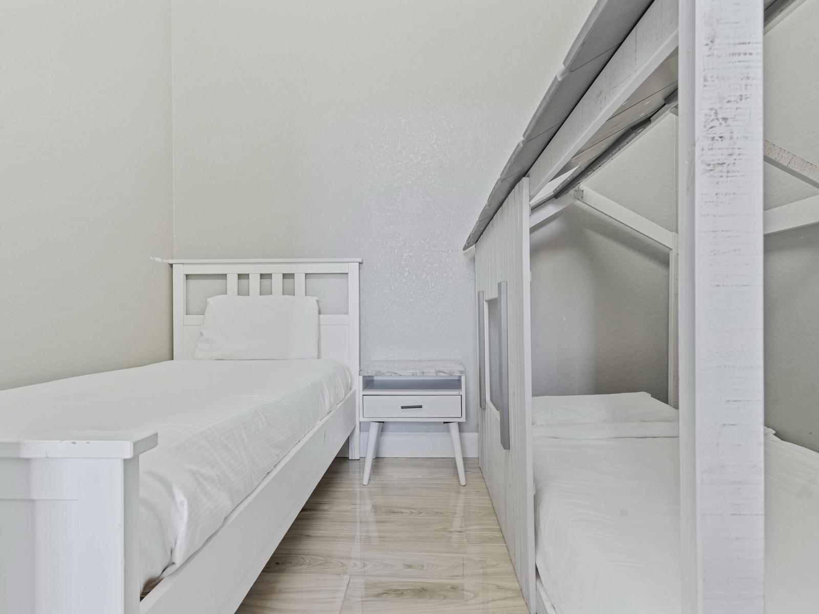 Dream Haven double bedroom for kids of the condo in Orlando Florida - Transform bedtime into a mesmerizing adventure where imagination and comfort come together -  White-themed kids' bedroom as a serene retreat providing a peaceful paradise