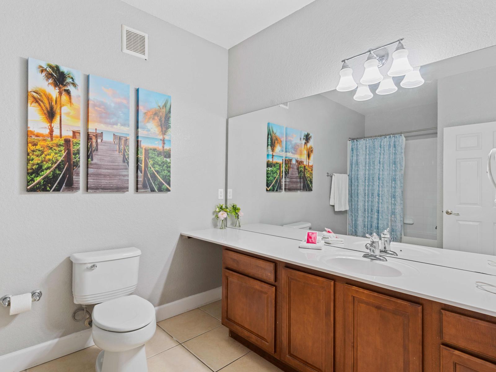 Well designed bathroom of the condo in Orlando Florida - Sleek and modern design elements in the bathroom - Offers sufficient room for toiletries and personal items.