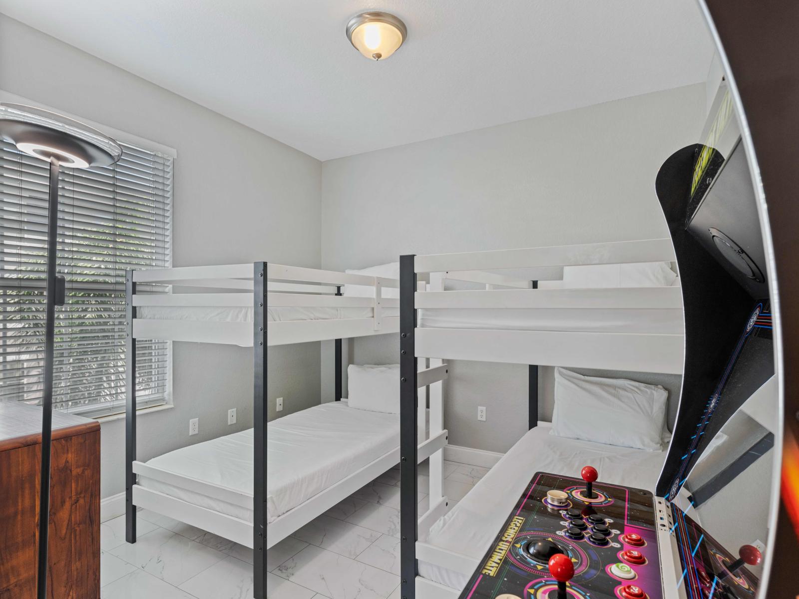 Bedroom 3 offers a delightful retreat for the kids, featuring two single size bunk beds that promise cozy nights and adventurous dreams. Adding to the fun, an arcade game awaits, ensuring endless entertainment and excitement.