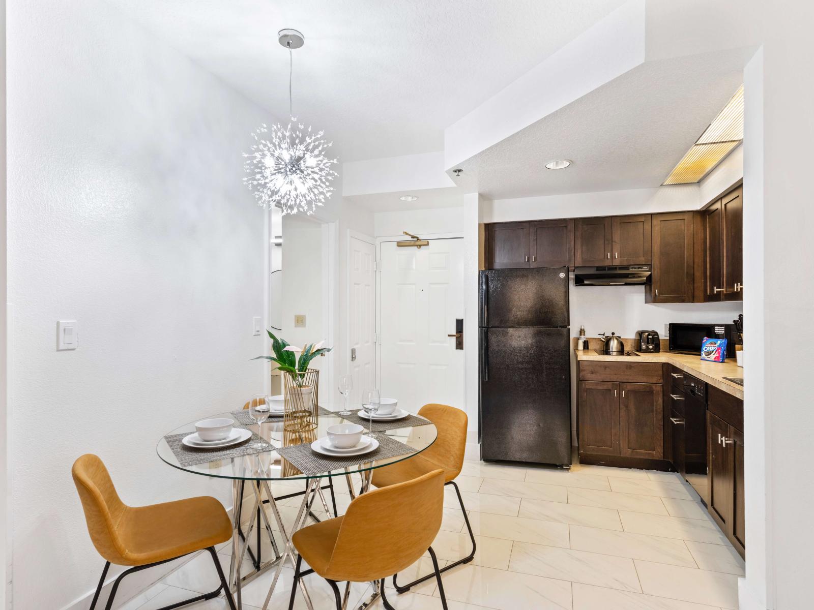 Living room with large smart TV, sleeper sofa and kitchen