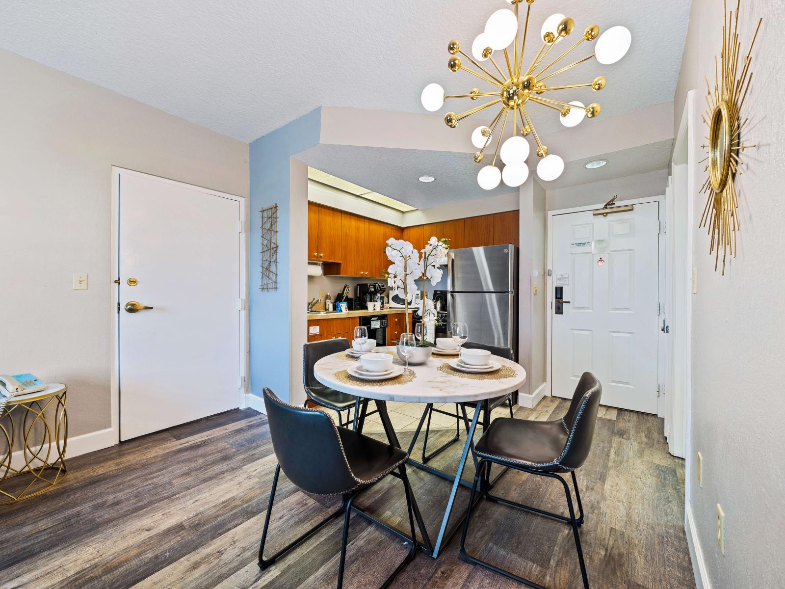 Sleek dining area of the condo in Orlando Florida - Sophisticated design with a blend of modern and classic elements - Elegant table setting for sophisticated dining