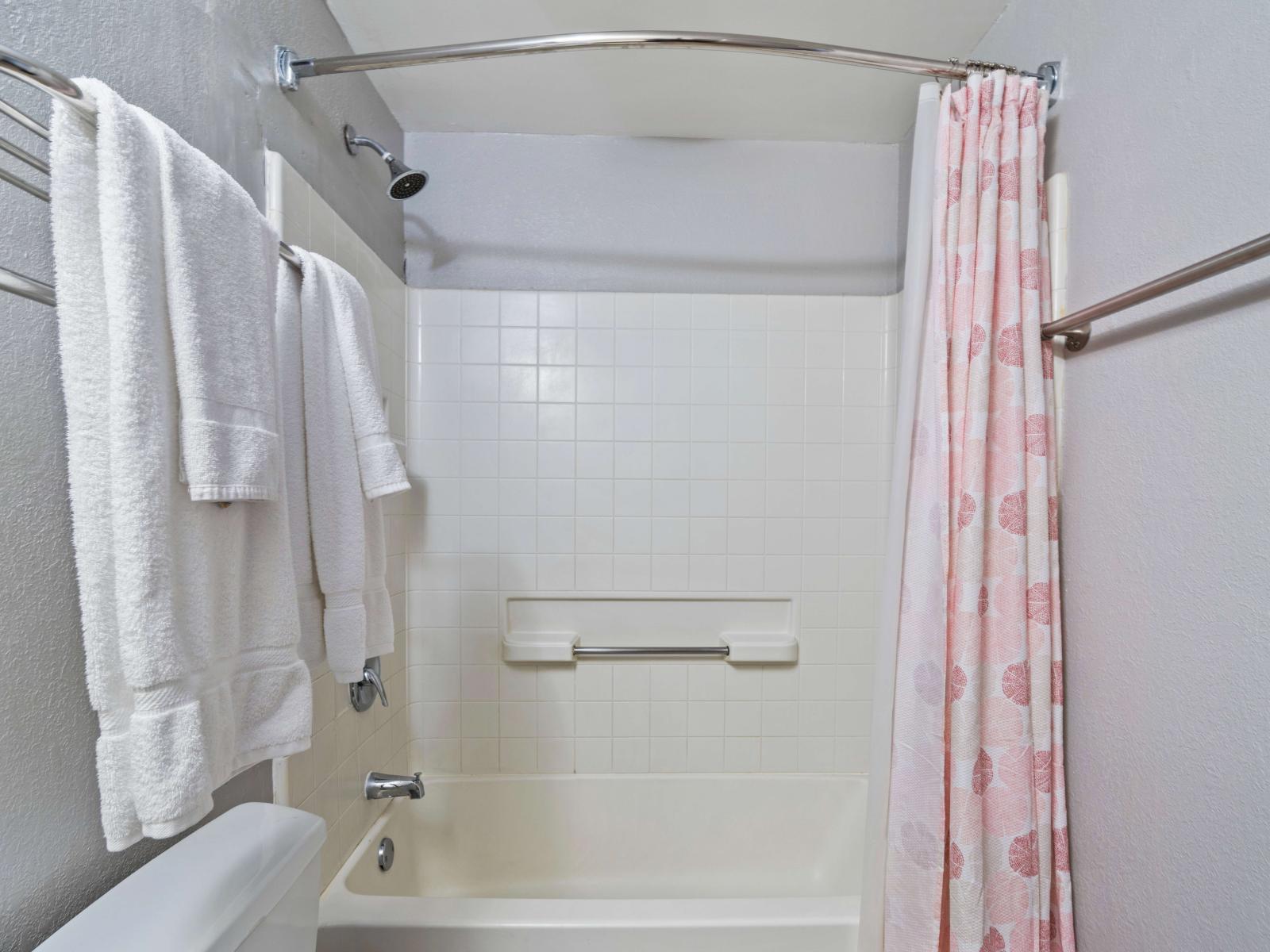 Sleek bathroom of the condo in Orlando Florida - Bathtub and a shower combo - Sophisticated color palette creating a serene ambiance - Sliding curtain for added privacy