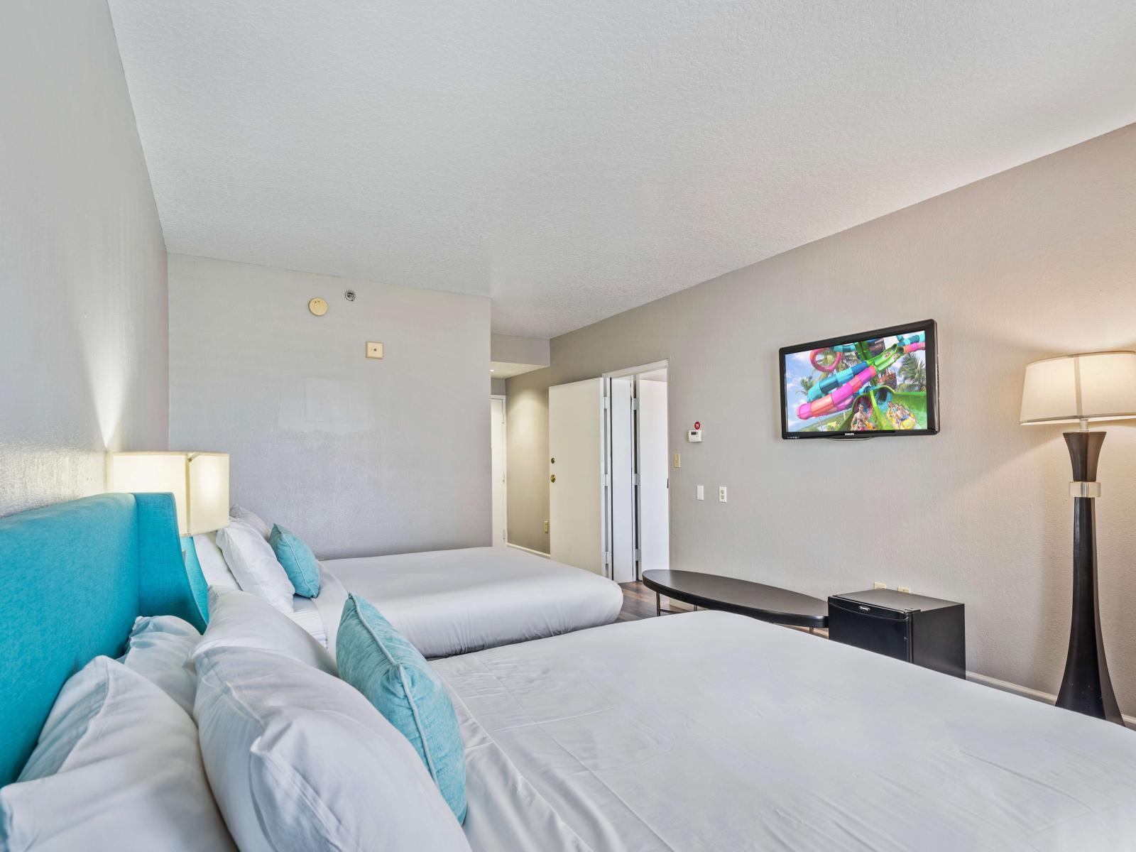 Spacious bedroom of the condo in Orlando Florida - Featuring two comfy double beds for relaxing nights - En-suite bathroom for convenience - Smart TV to watch your favorite movies and TV shows