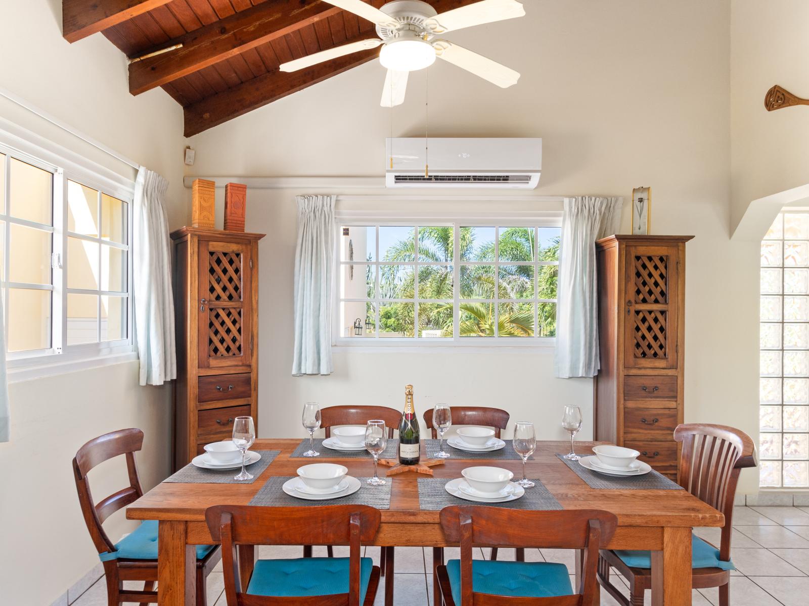 Opulent Dining Area of the home in Noord Aruba - Chic dining area with inviting ambiance - Elegant table setting for sophisticated dining - Large windows offering a scenic dining experience - 6 Persona Dining