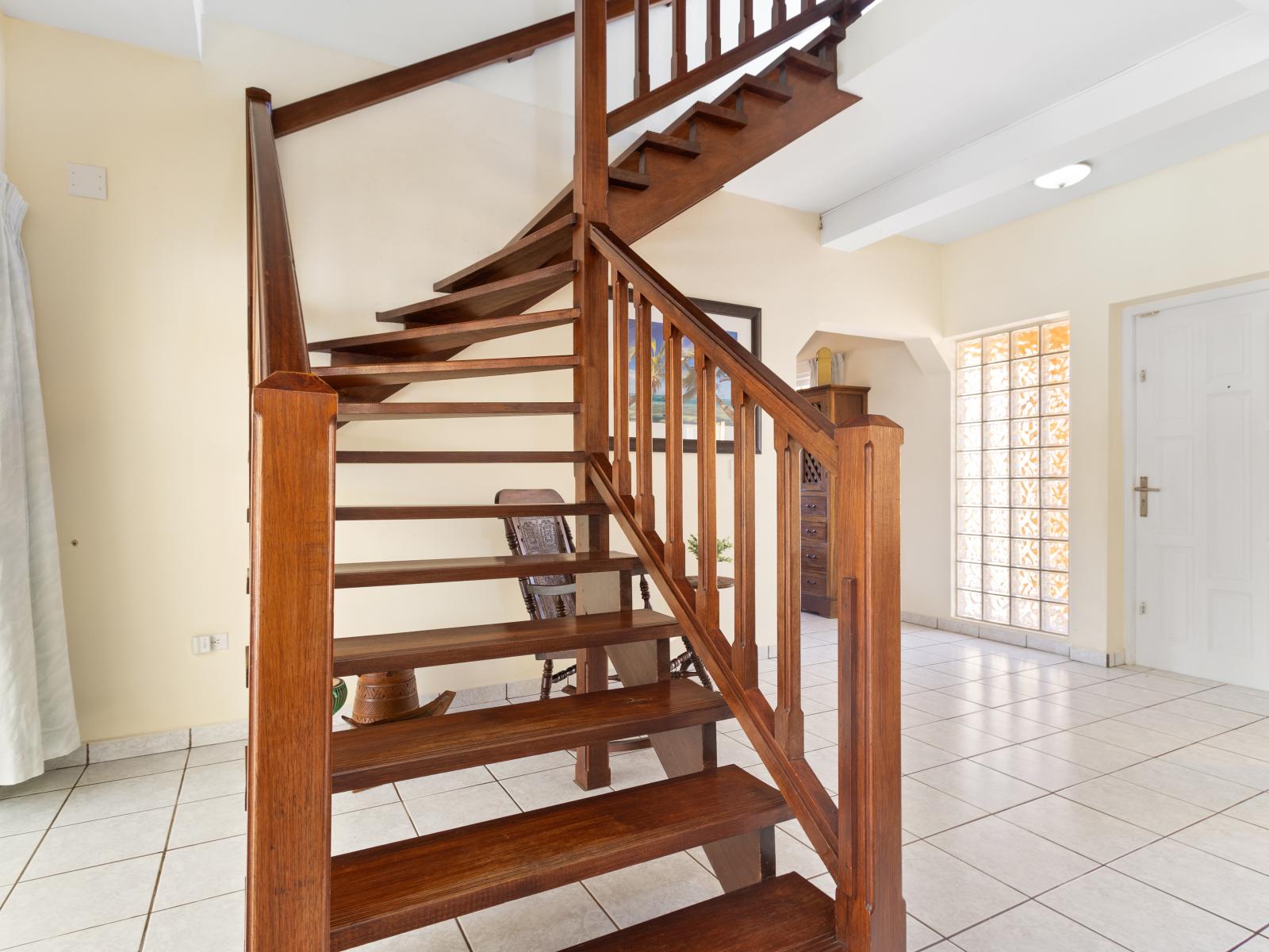 The beautifully crafted stairway provides access to the bedrooms, enhancing the home's charm and accessibility.