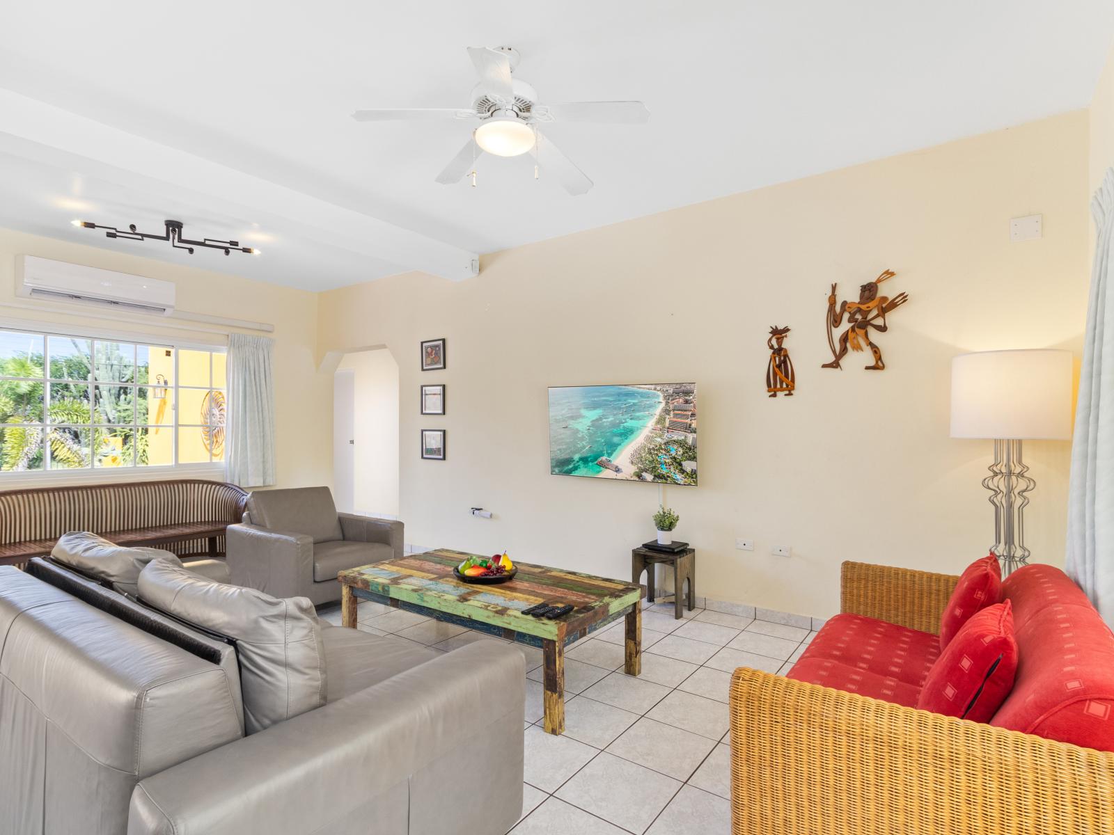 Spacious Living Area of the home in Noord Aruba - Smart TV and Netflix - Natural light floods the room, enhancing its warmth and inviting atmosphere - Comfy Sofas - High-end finishes and refined details