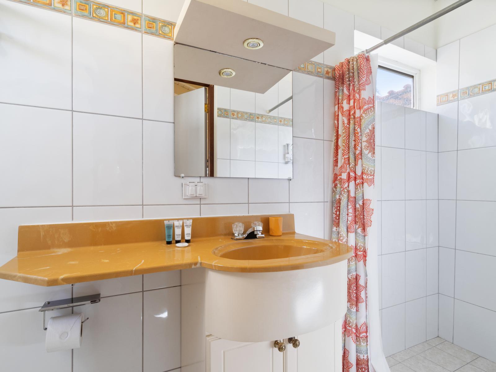 Bathroom 3 is equipped with a convenient vanity, a modern toilet, and a walk-in shower, designed to provide both comfort and style.