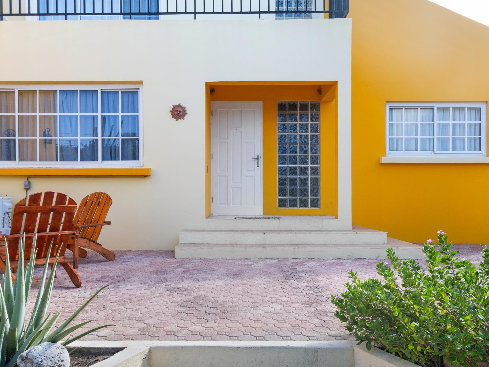 Inviting Front Door of the Vibrant Home in Noord Aruba -  Warm and inviting atmosphere - Elegantly blending tradition and modernity in its design - A captivating lined with architectural charm