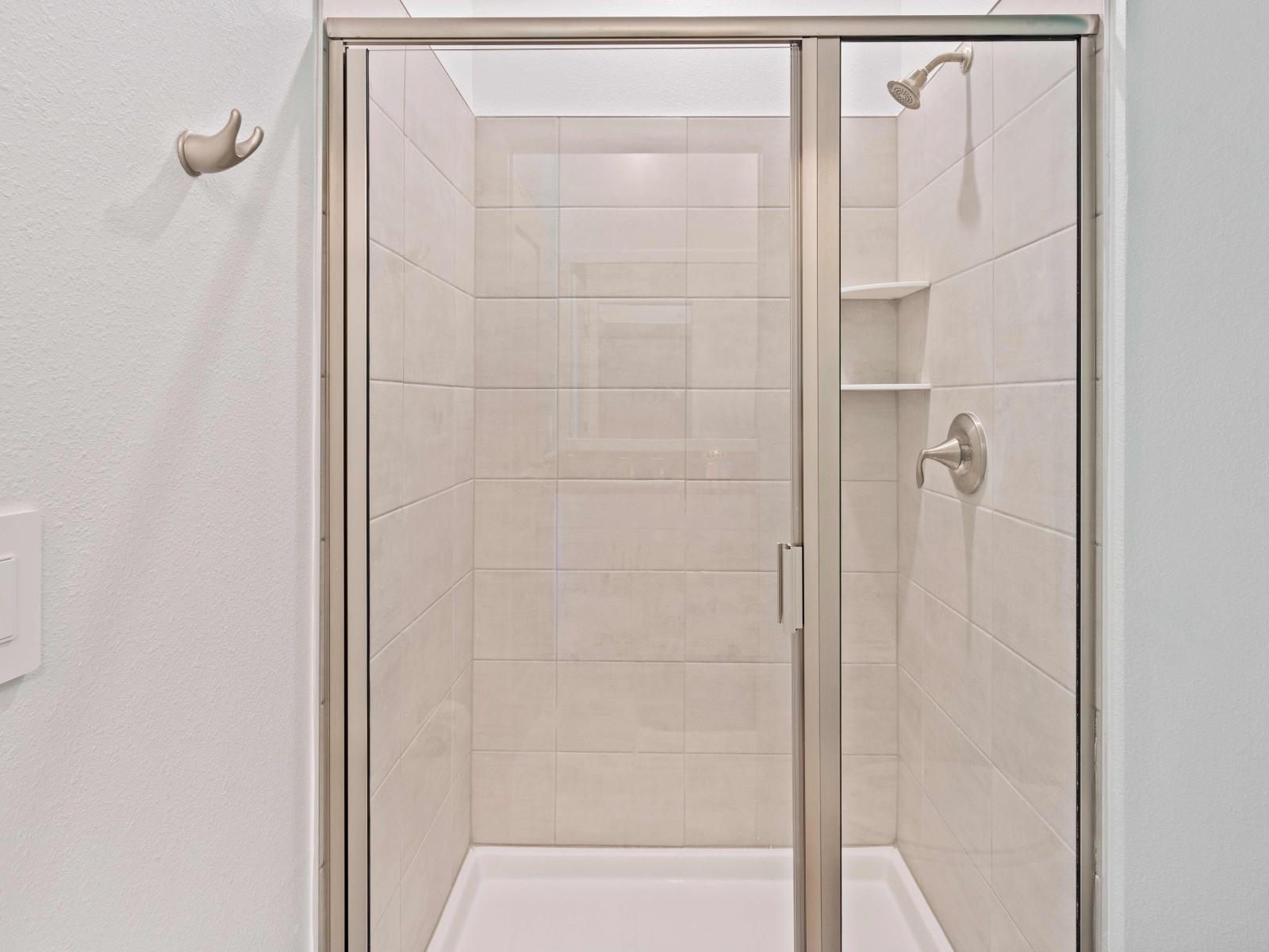 Enjoy the sleek design of Bathroom 1, complete with a convenient walk-in shower.