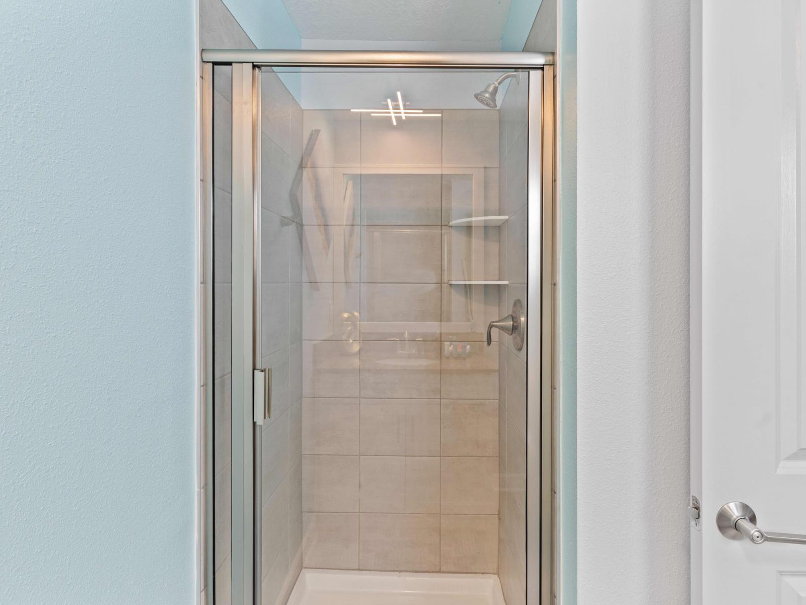 Experience relaxation in Bathroom 4's spacious walk-in shower, designed for your comfort and rejuvenation.