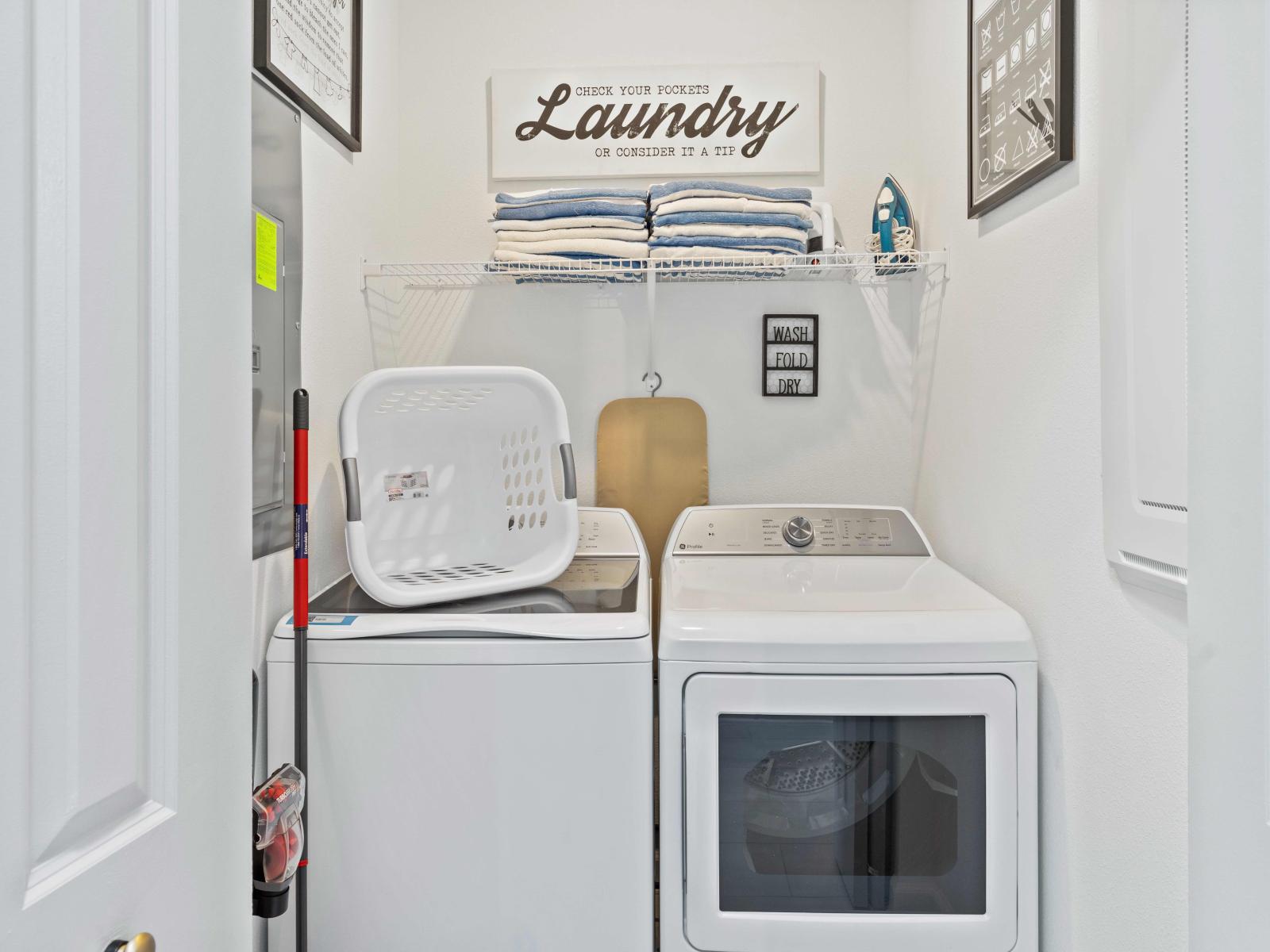 Convenient laundry room equipped with full-sized washer and dryer for all your laundry needs.