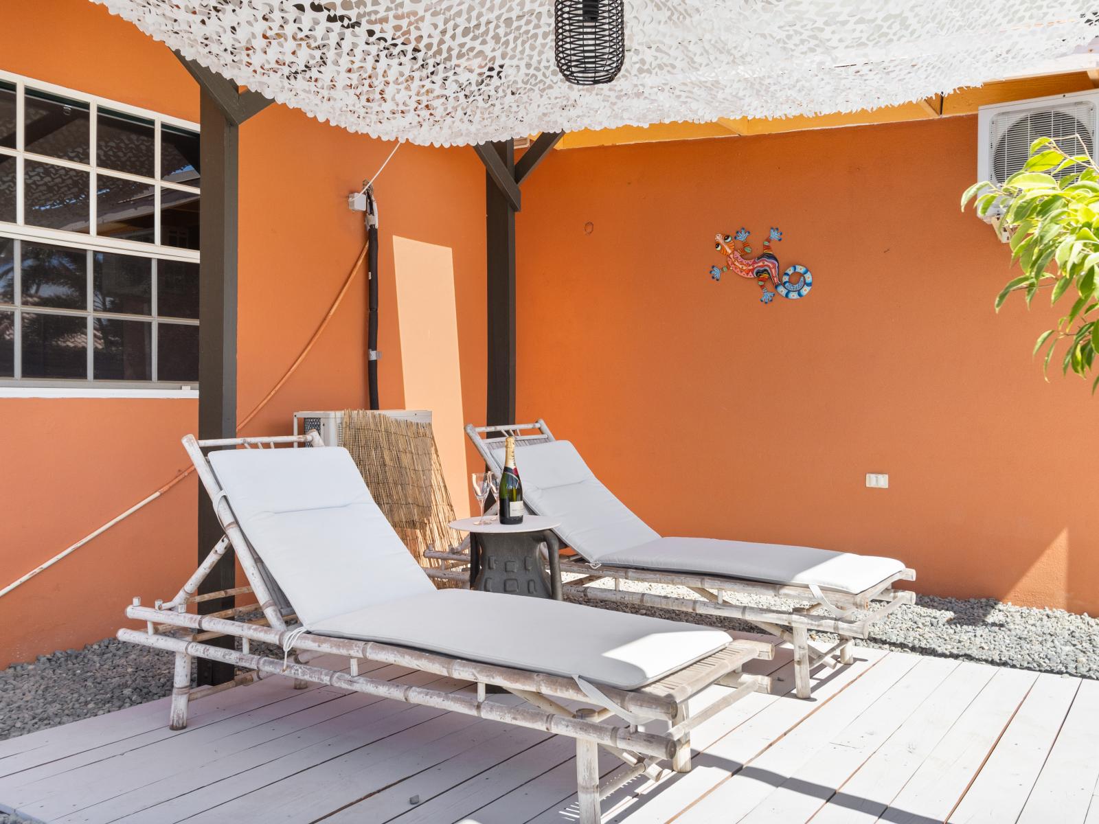 Lounge chairs of the 3BR House in Noord Aruba - Stunning pool views - Experience ultimate relaxation in our poolside paradise - Inviting pool area for a perfect getaway