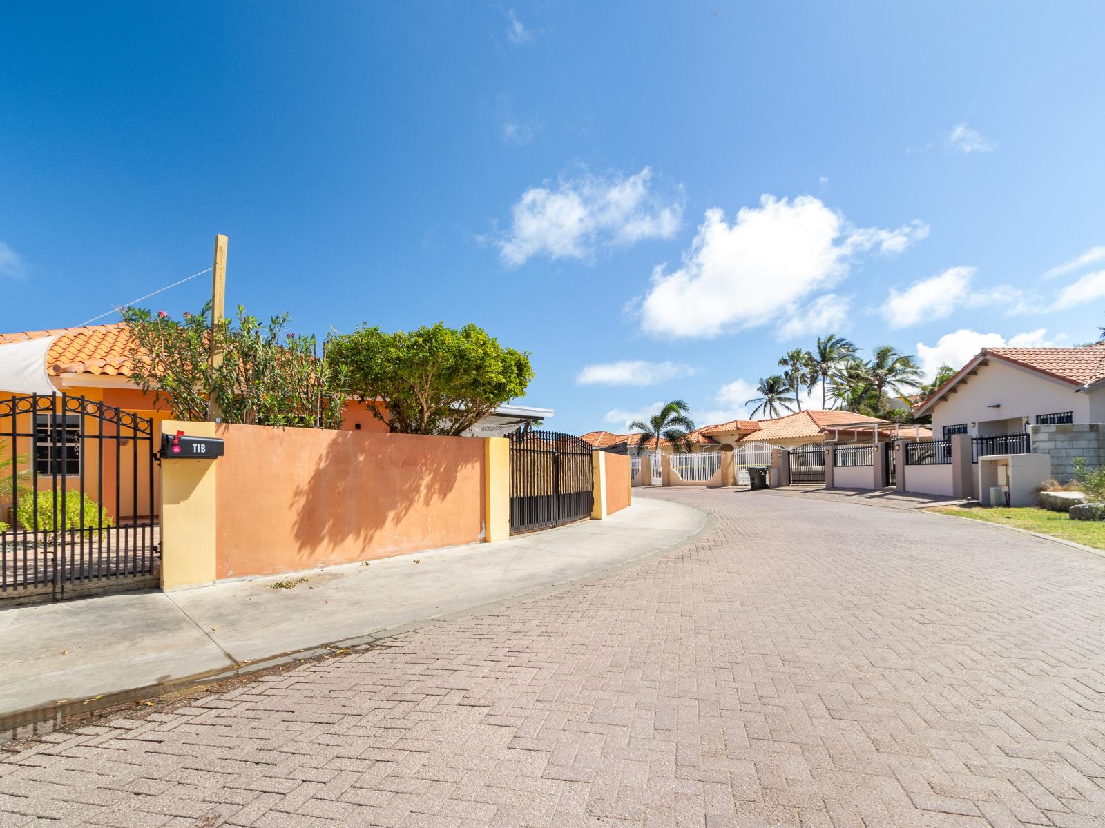 Peaceful neighbourhood in Noord Aruba - Nestled in the city center, radiating Mediterranean charm - A picturesque avenue boasting timeless beauty - Vibrant foliage creating a serene atmosphere