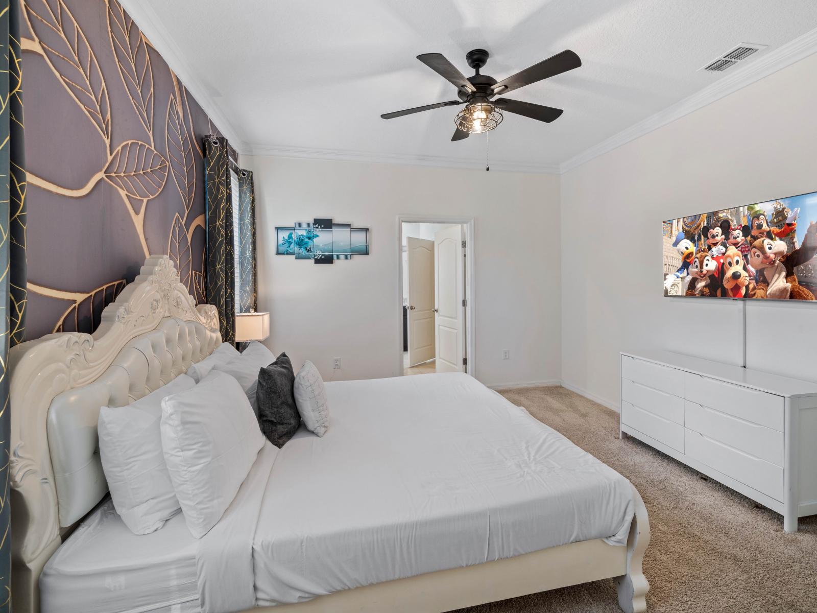 Relax in Bedroom 2's serene ambiance, featuring a king-size bed and private bathroom, perfect for unwinding.