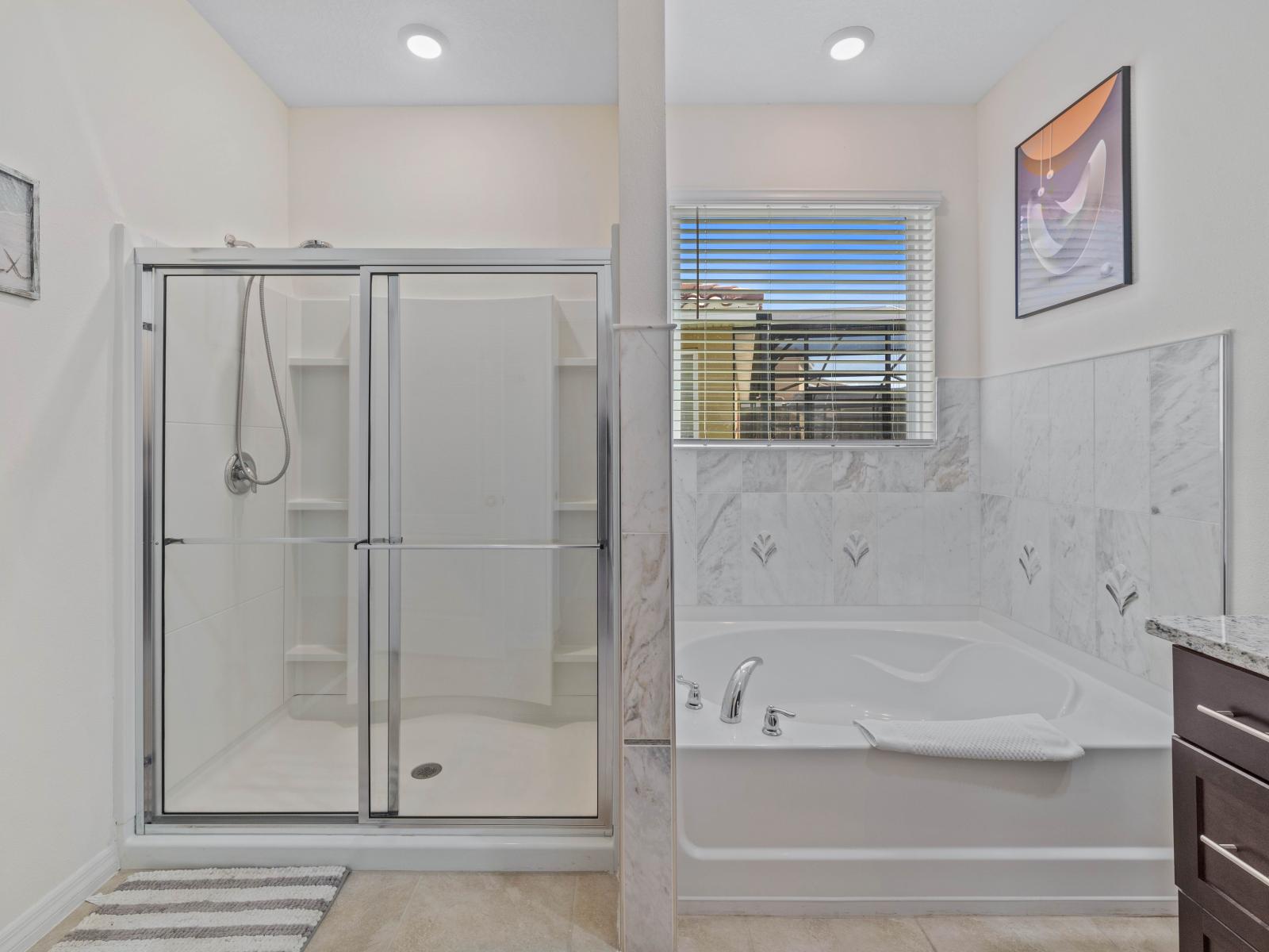 Luxuriate in Bathroom 2, offering the choice of a soothing bathtub and a refreshing walk-in shower.