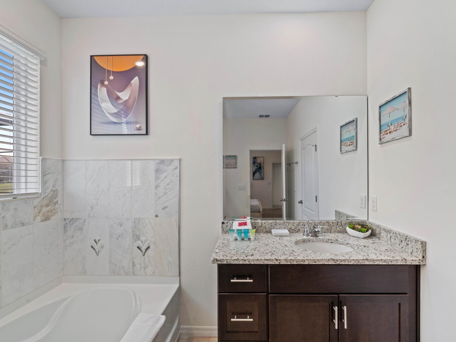 Experience the best of both worlds in Bathroom 2, featuring a relaxing bathtub and a convenient walk-in shower.