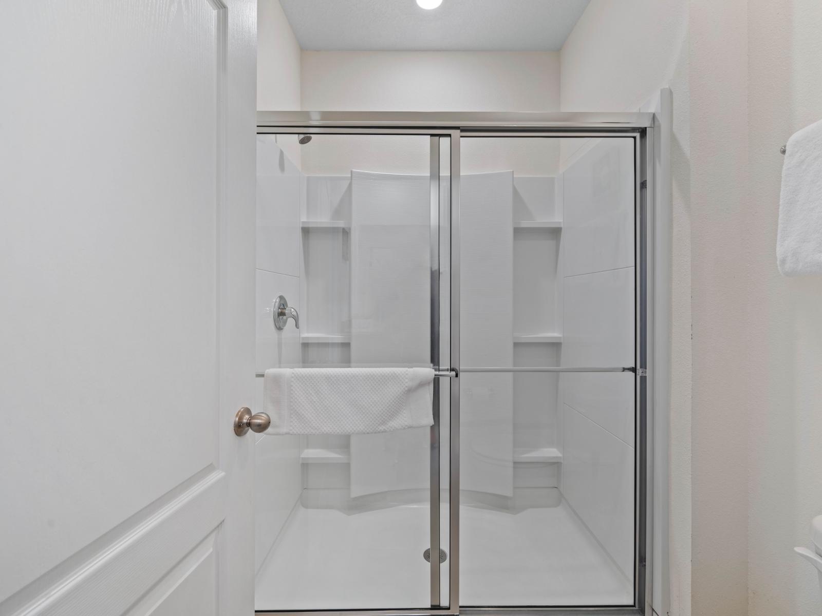 Experience modern elegance in Bathroom 3, featuring a spacious walk-in shower for your comfort.