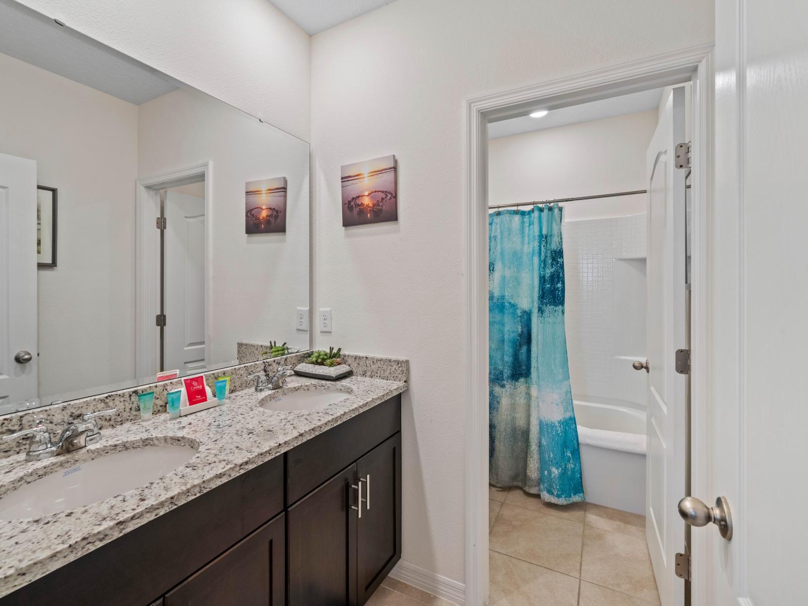 Experience comfort and luxury with the expansive walk-in shower of Bathroom 5.