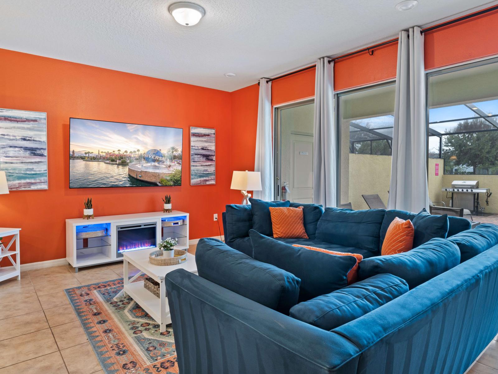 Step into our inviting living room oasis with its vibrant and playful atmosphere. With expansive seating, it's the ultimate setting for enjoying shows, movies, games, and more, with convenient access to the pool.