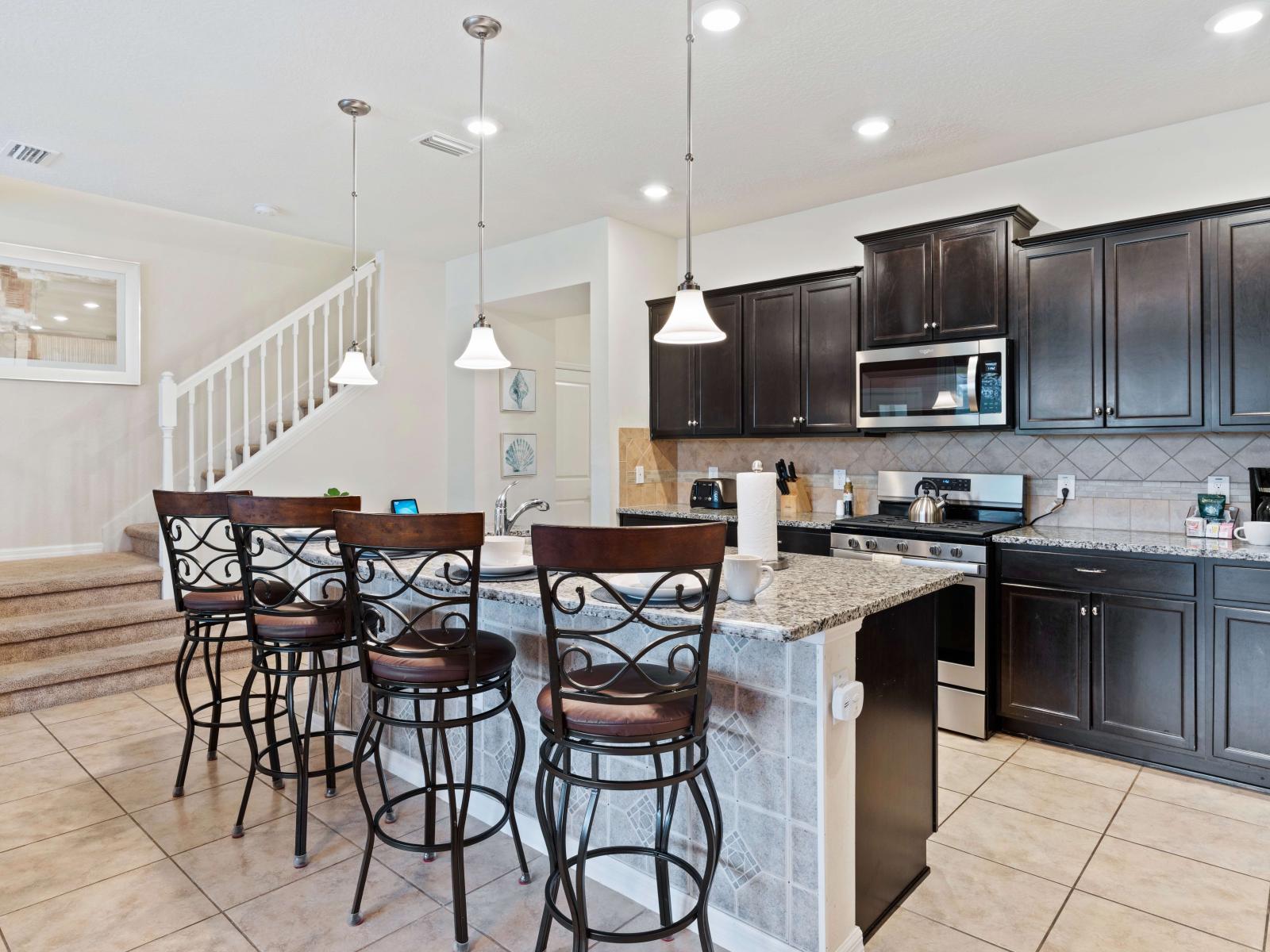 Full equipped kitchen- fronting the counter table to grab a snack or a quick coffee break