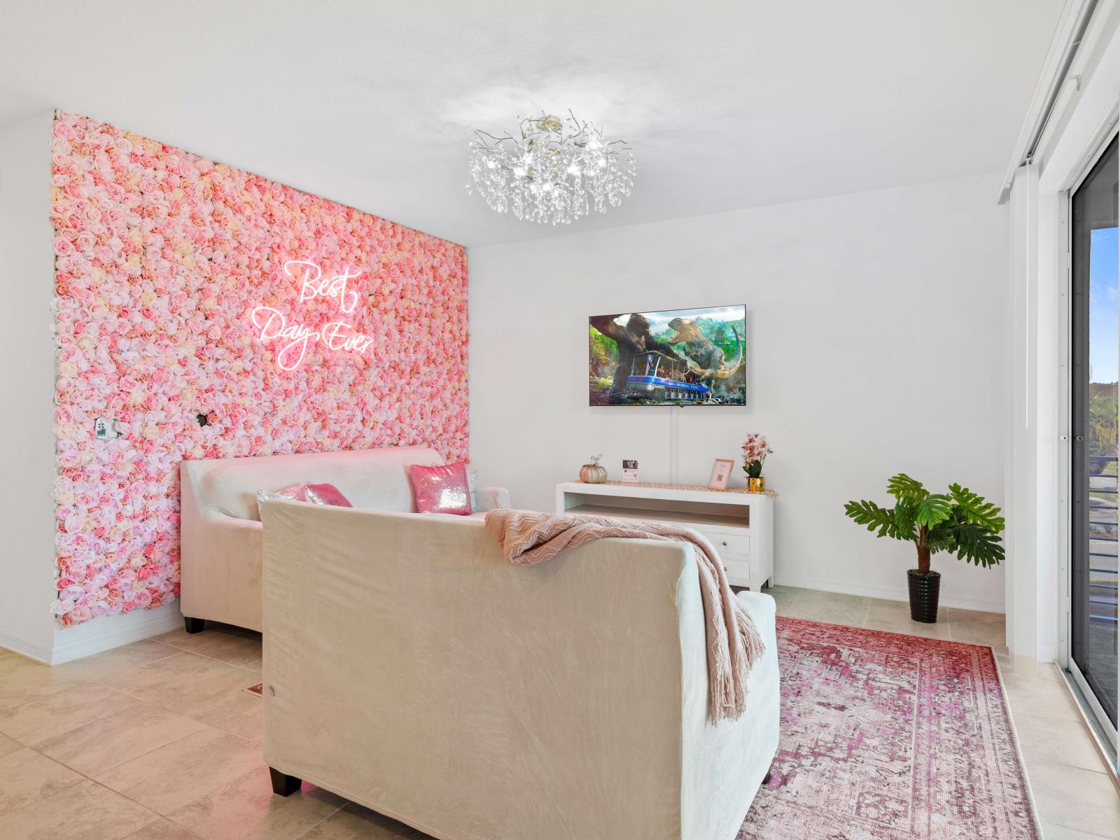 A studio like design of the living area with a floral background wallpaper fronting the private balcony