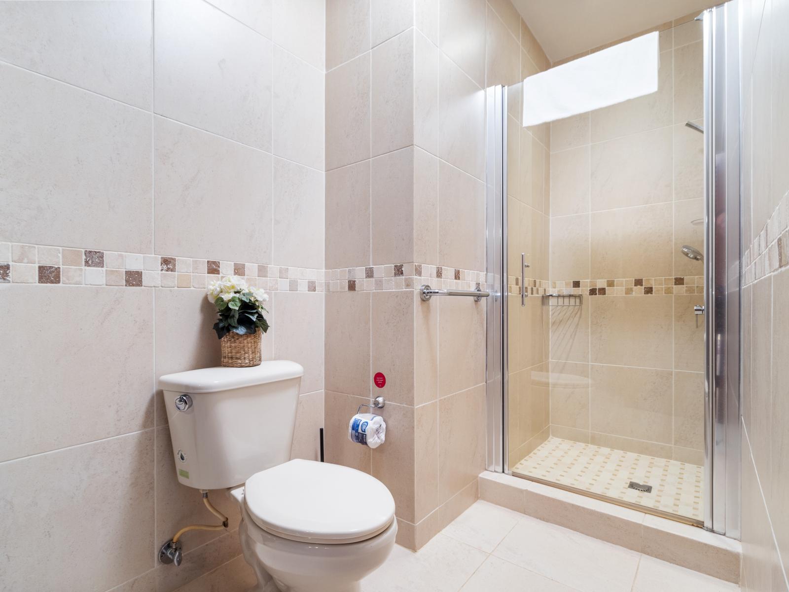Experience relaxation in the second bedroom's bathroom, complete with a stylish walk-in shower.