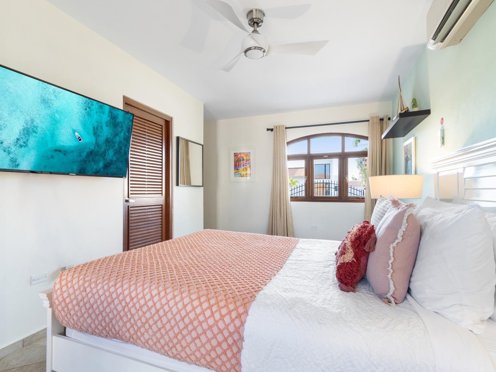Bedroom 3 is equipped with a wall-mounted flat-screen TV for your entertainment.