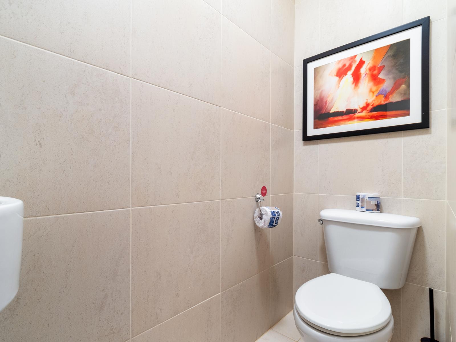Freshen up in our chic half bathroom, featuring modern amenities and a clean design.