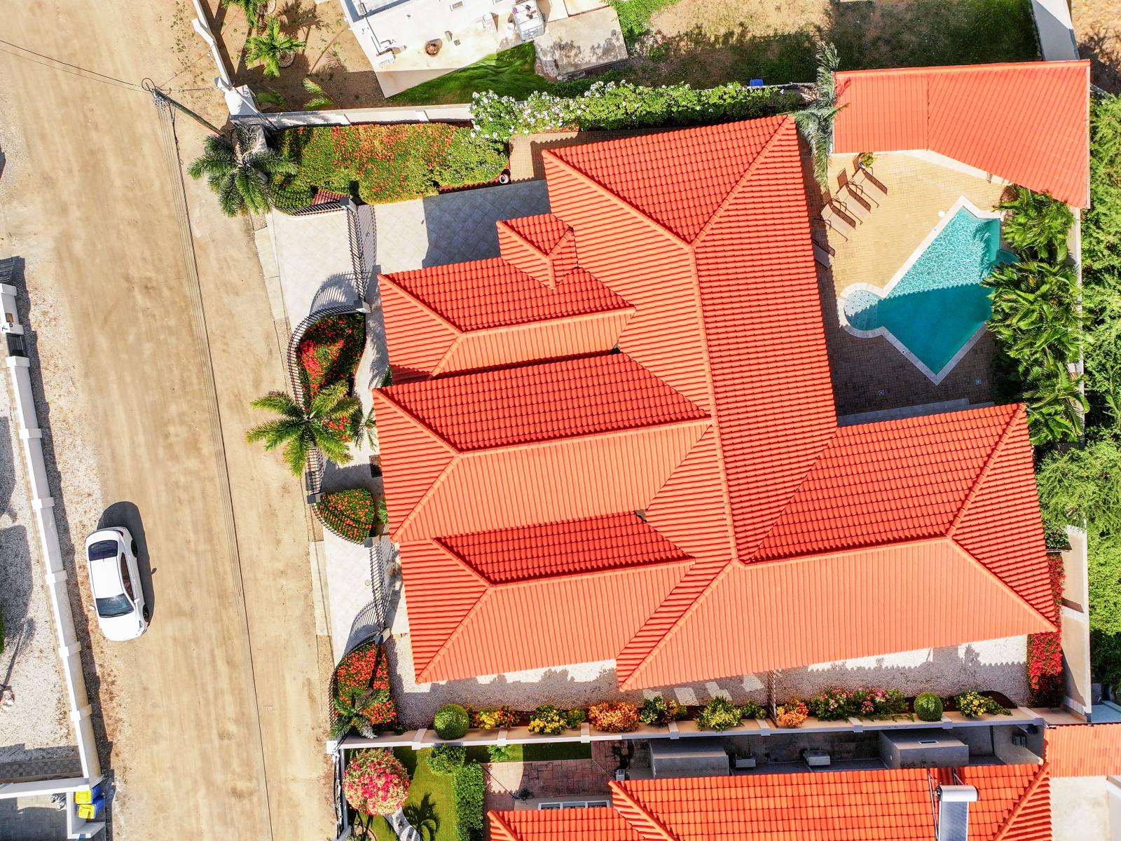 Aerial view of the villa captured by drone.