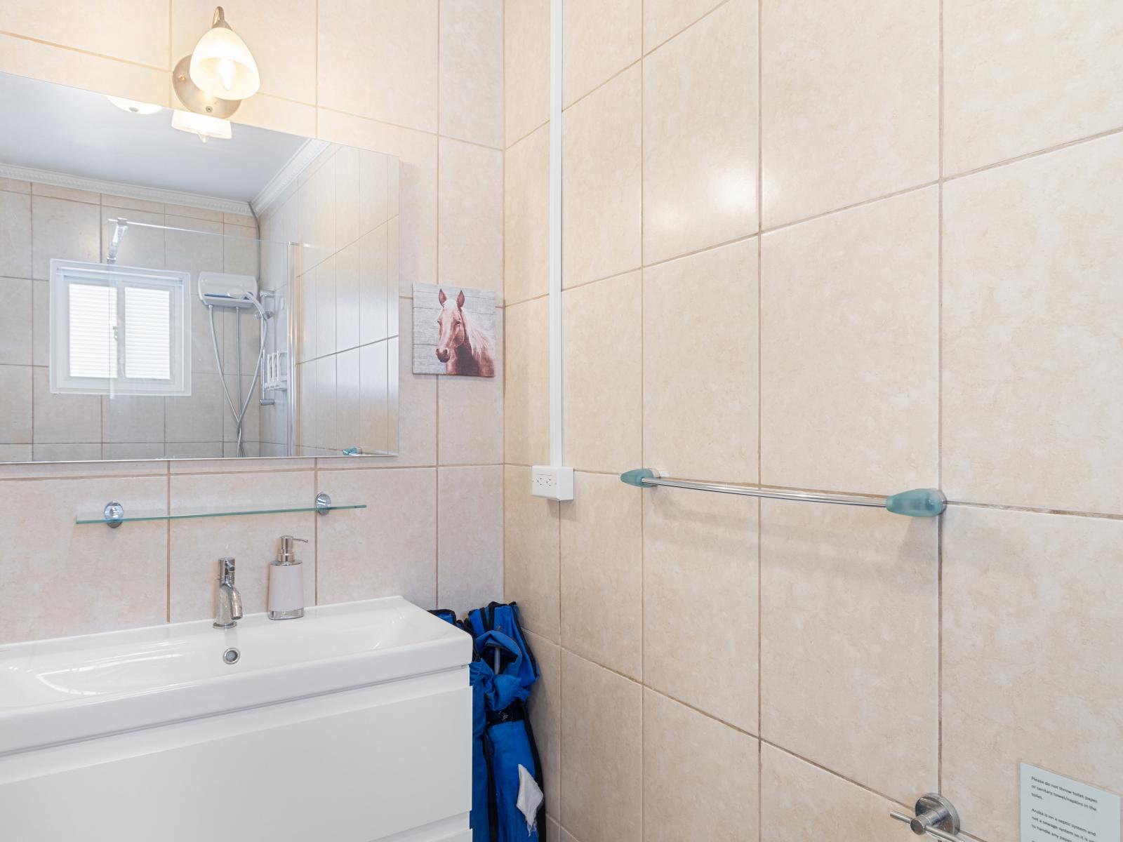 Refresh and rejuvenate in Bathroom 1, featuring a spacious walk-in shower designed for your comfort and relaxation.