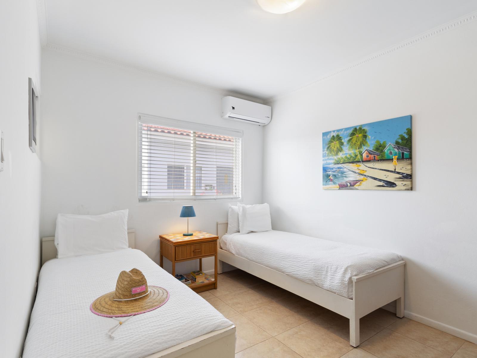 Superb bedroom of the 2BR condo in Noord Aruba - Twin comfortable bed - Cozy retreat with a plush bed, perfect for relaxation - Modern and stylish decor that complements the space