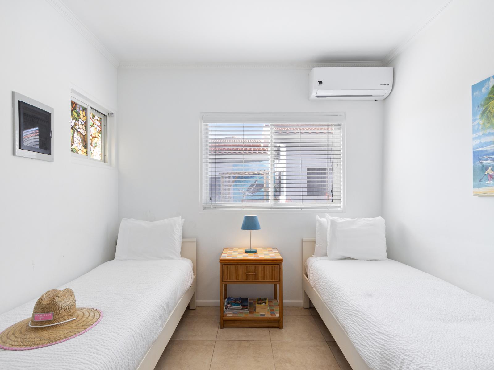 Eminent Bedroom of the 2BR condo in Noord Aruba - Luxurious bedding for a restful night's sleep - Windows for natural lighting - Ample storage with spacious closets and dressers