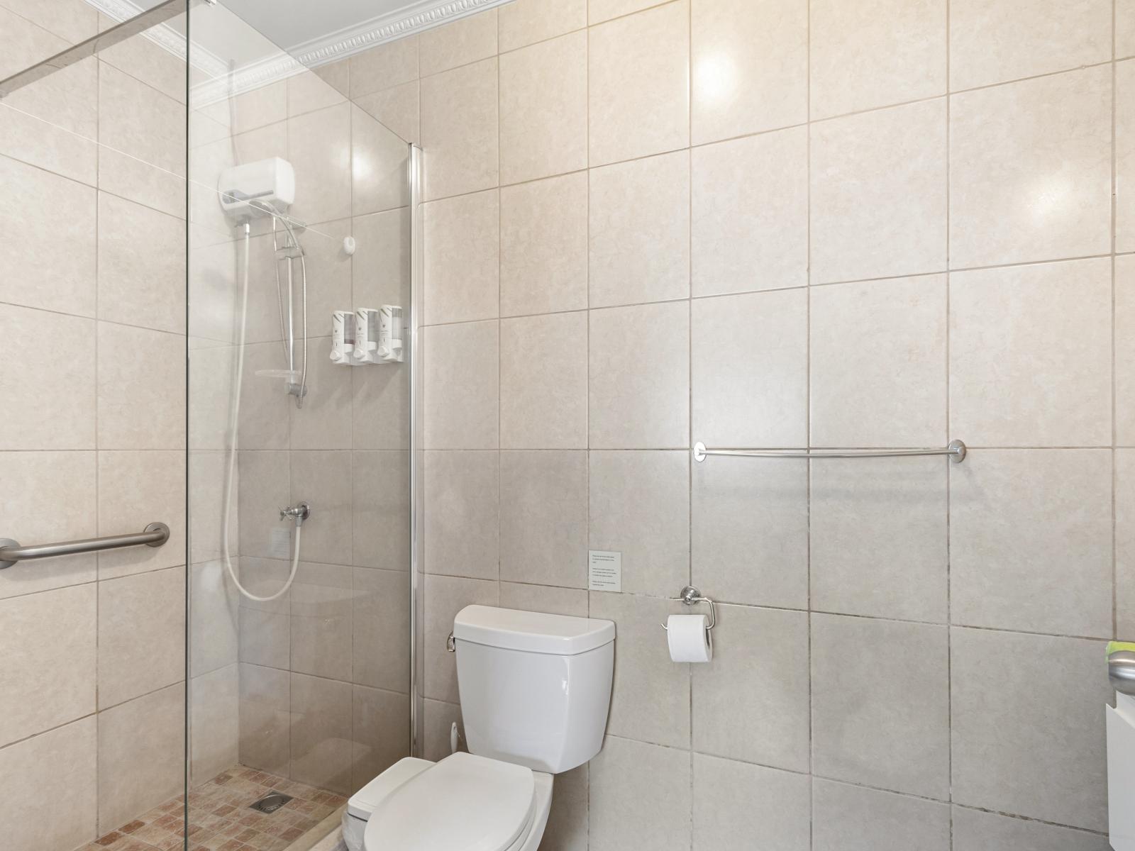 Magnificent Bathroom of the 2BR condo in Noord Aruba - Sophisticated color palette creating a serene ambiance - Contemporary fixtures for a touch of indulgence - Glass enclosed shower Area