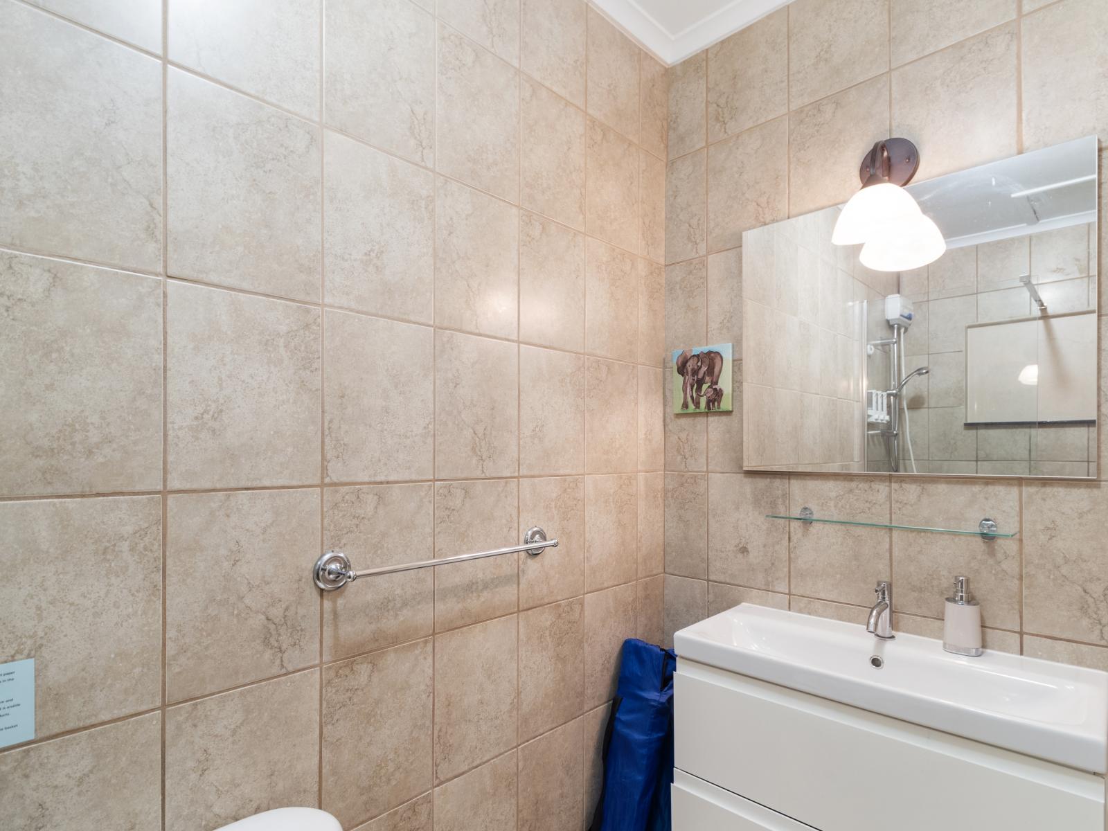 Superb Bathroom of the Apartment in Noord Aruba - Elegant bathroom with high-end fixtures and finishes - Well-lit space with strategically placed mirrors for a spacious feel