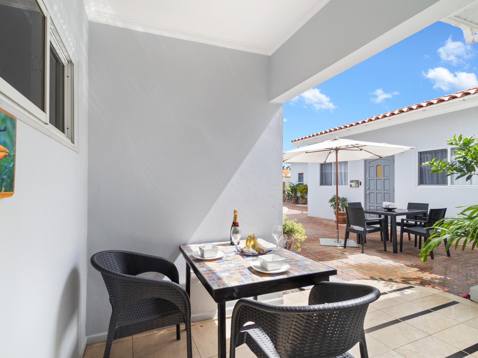 Refreshing Covered patio Area of the Apartment in Noord Aruba - 2 Persons Dining - Turn your meal into a brief getaway from indoor - Pleasant Atmosphere