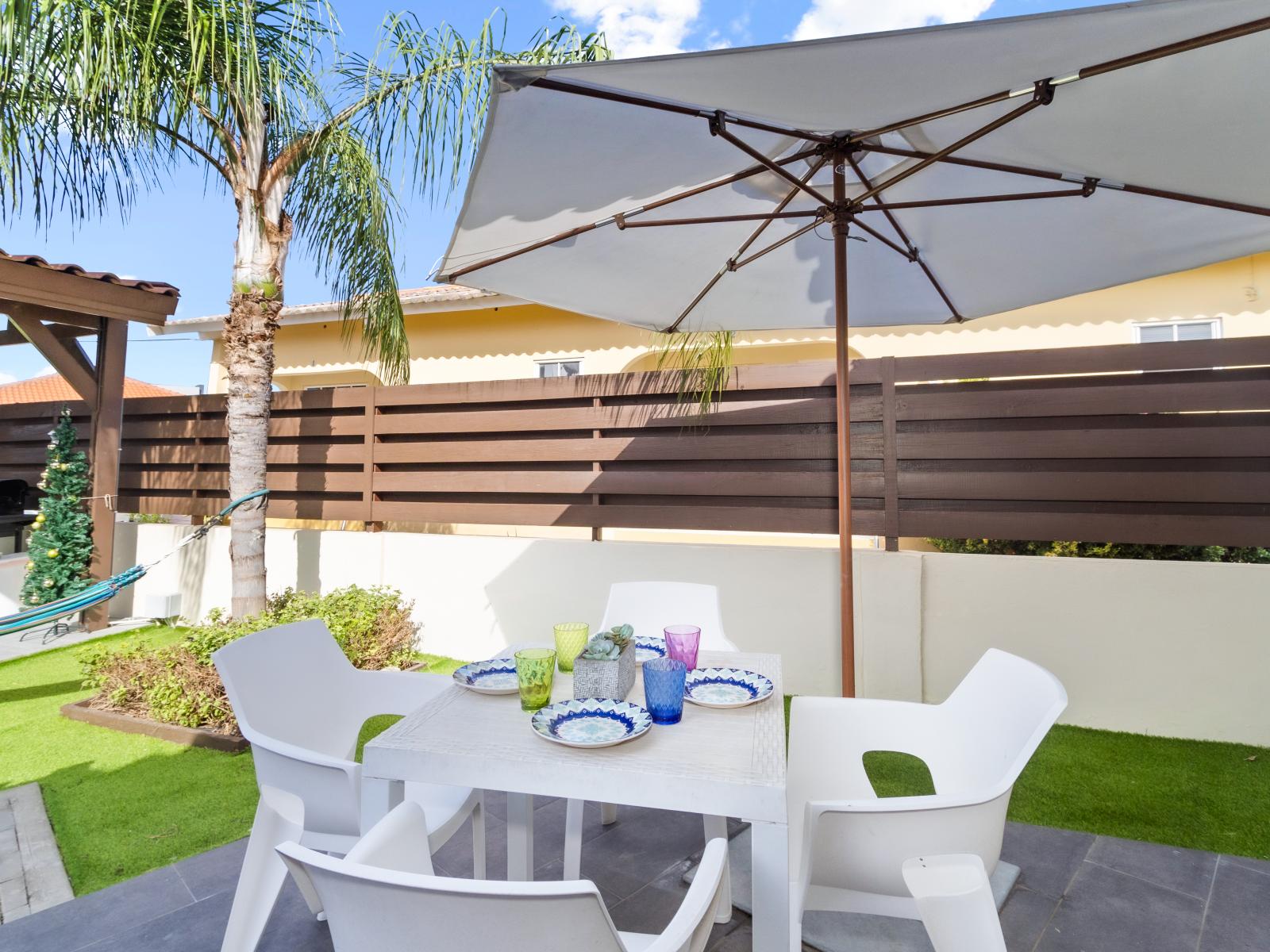 Cozy private patio of the Apartment in Noord Aruba near Palm Beach - Enjoy stunning surroundings while you dine - Refreshing Environment - 4 Persons Dining - Shade for sensitive guests