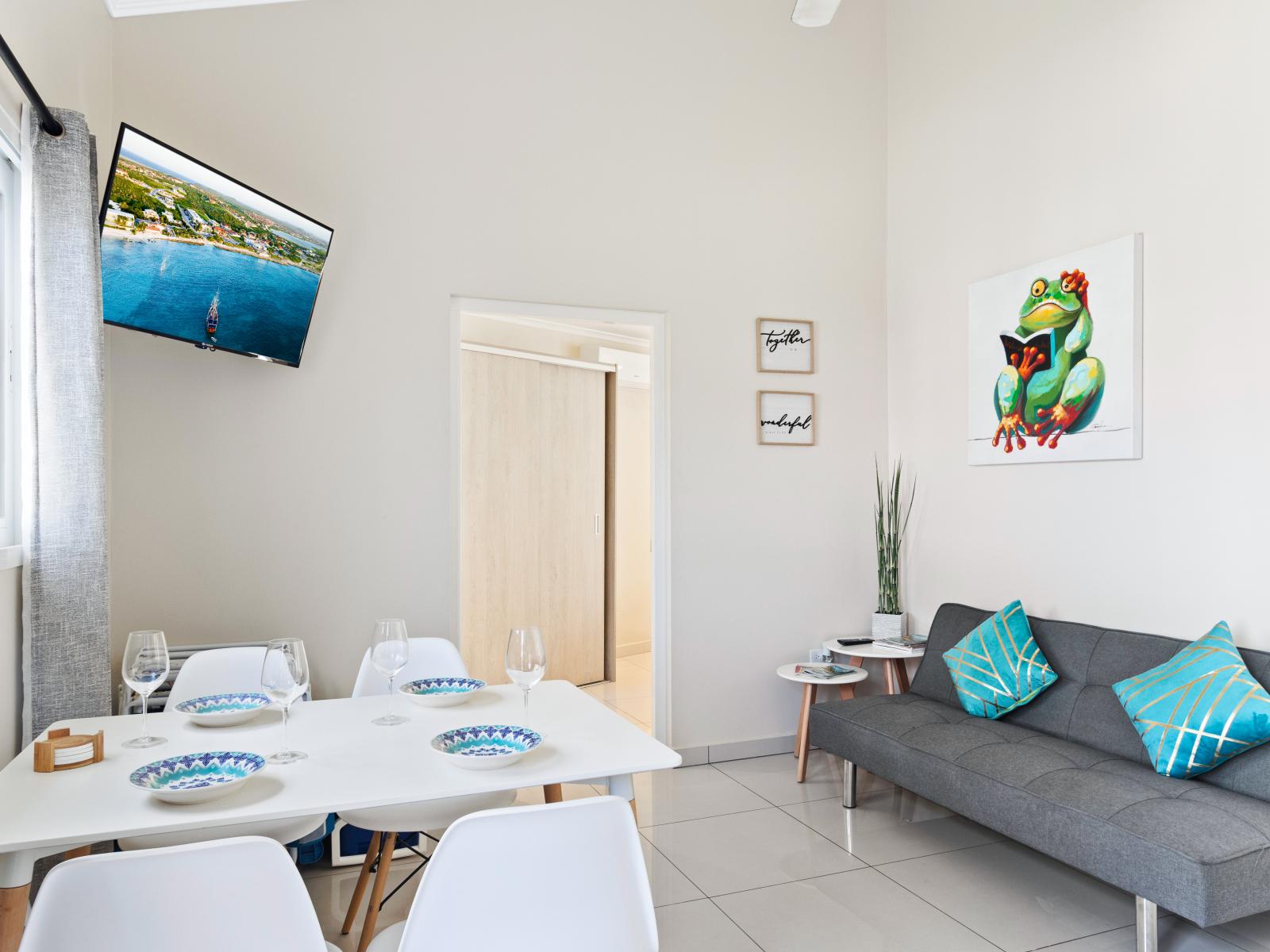 Charming Living and Dining Area of the Apartment in Barcelona Spain - Open-plan design for a modern feel - Smart TV and Netflix - Ample natural light through windows. - Elegant Decor