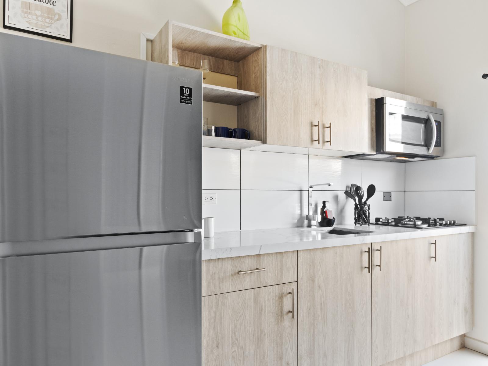 Lush Kitchen of the Apartment in Noord Aruba - Well-lit space with strategically placed task lighting - Elegant and coordinated color palette for a cohesive look - Fully Equipped